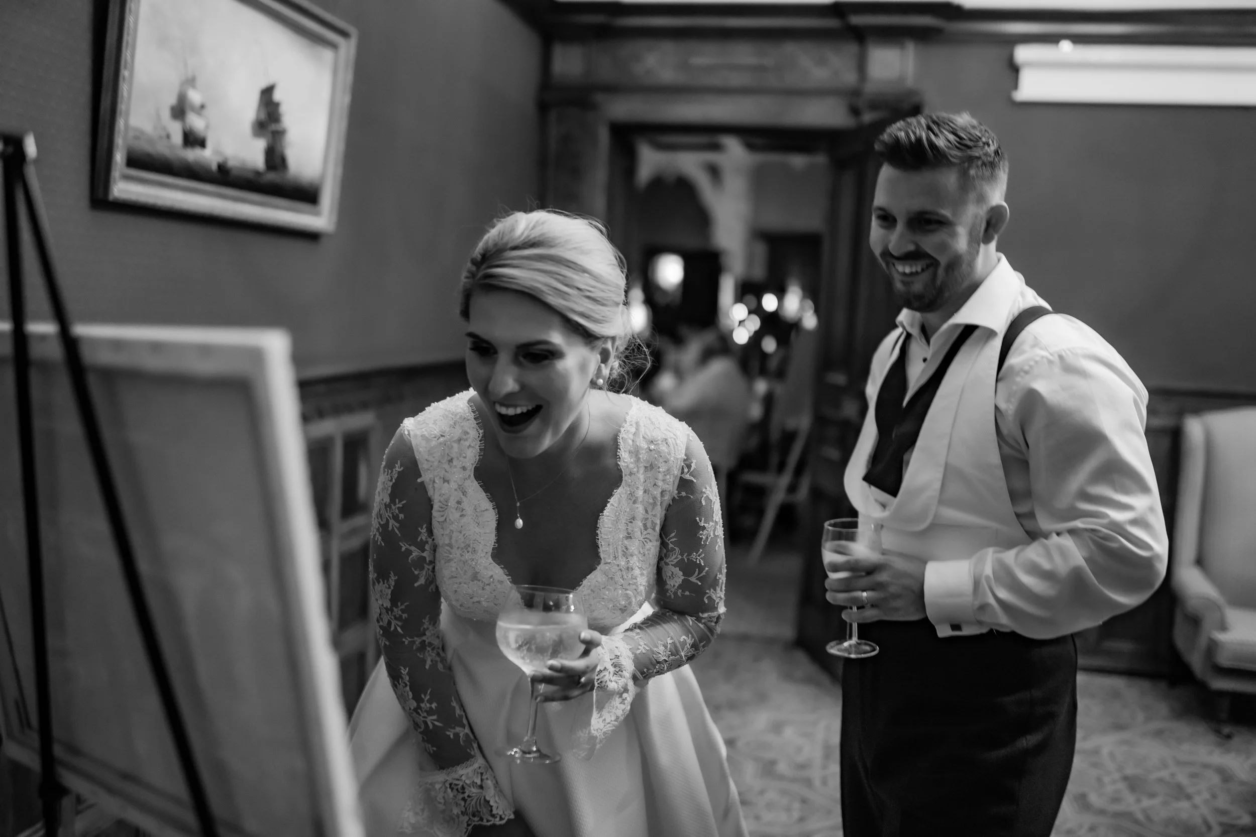 bride and groom admire their live wedding painting at Somerset wedding venue Clevedon Hall