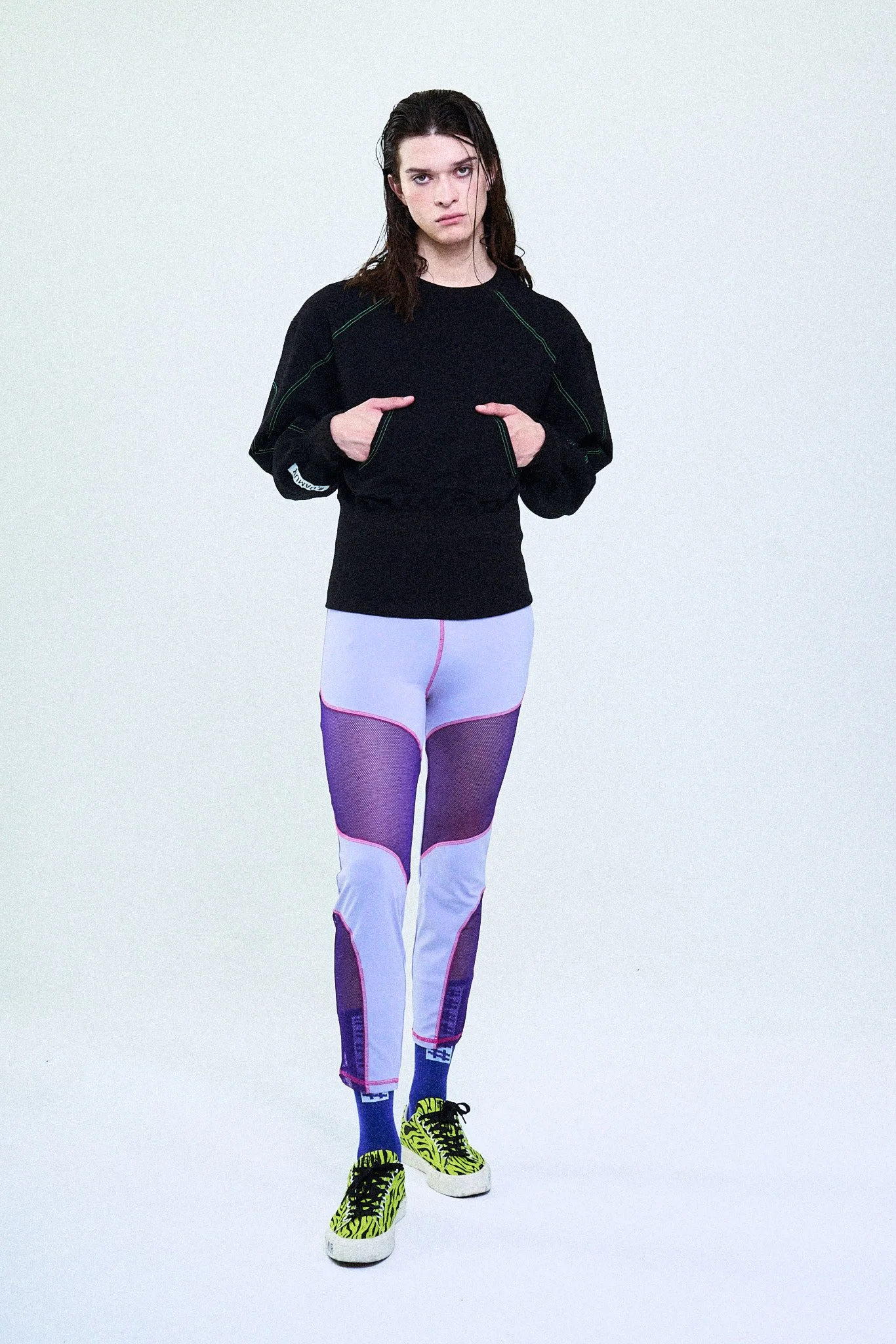 A person in colorful athletic clothing standing against a plain light background.