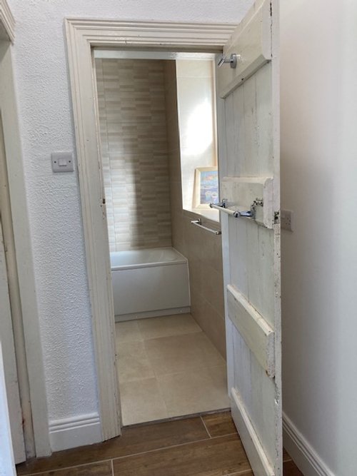 Downstairs bathroom with full bath, shower, vanity unit and toilet