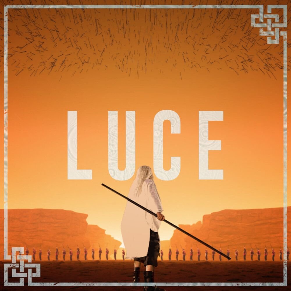 A person holding a spear, standing in front of a sunset landscape with cliffs and a line of soldiers, with the word 'LUCE' prominently displayed in the sky in large white letters.