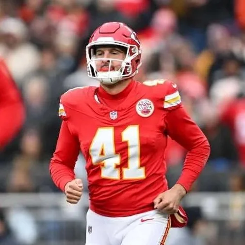 Football player wearing red Kansas City Chiefs uniform and helmet, number 41, celebrating during a game.