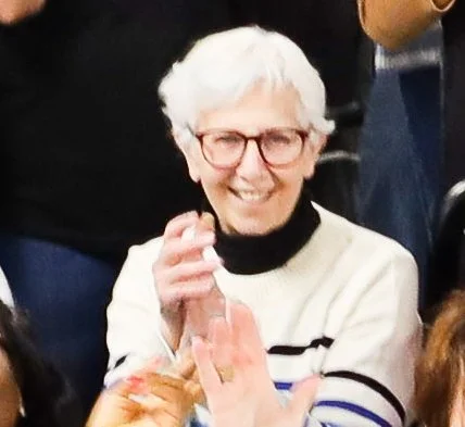 Ruth Fishbein is clapping and looking joyful at the Give Warmth Give Hope packing party 2025