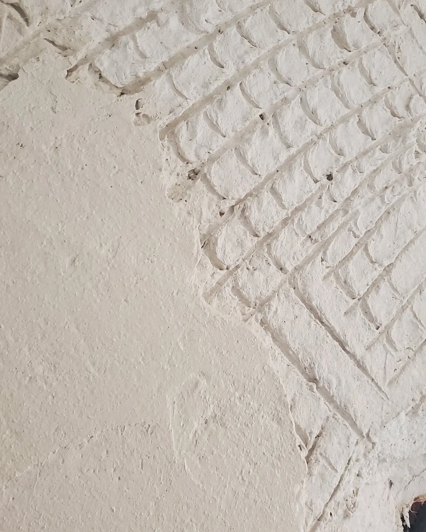 Lime finish going on over a traditional scratch coat

The scratched layer you see is the base coat&mdash;it&rsquo;s full of texture to help the next coat grip. This one&rsquo;s made with lime, sand, and patience. No cement. No shortcuts.

I&rsquo;ve 