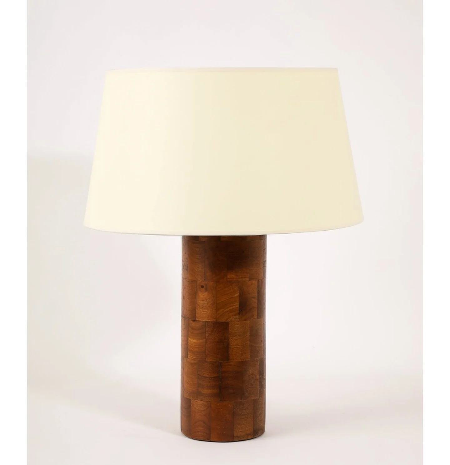 Circular table lamp made of turned walnut blocks- online now.