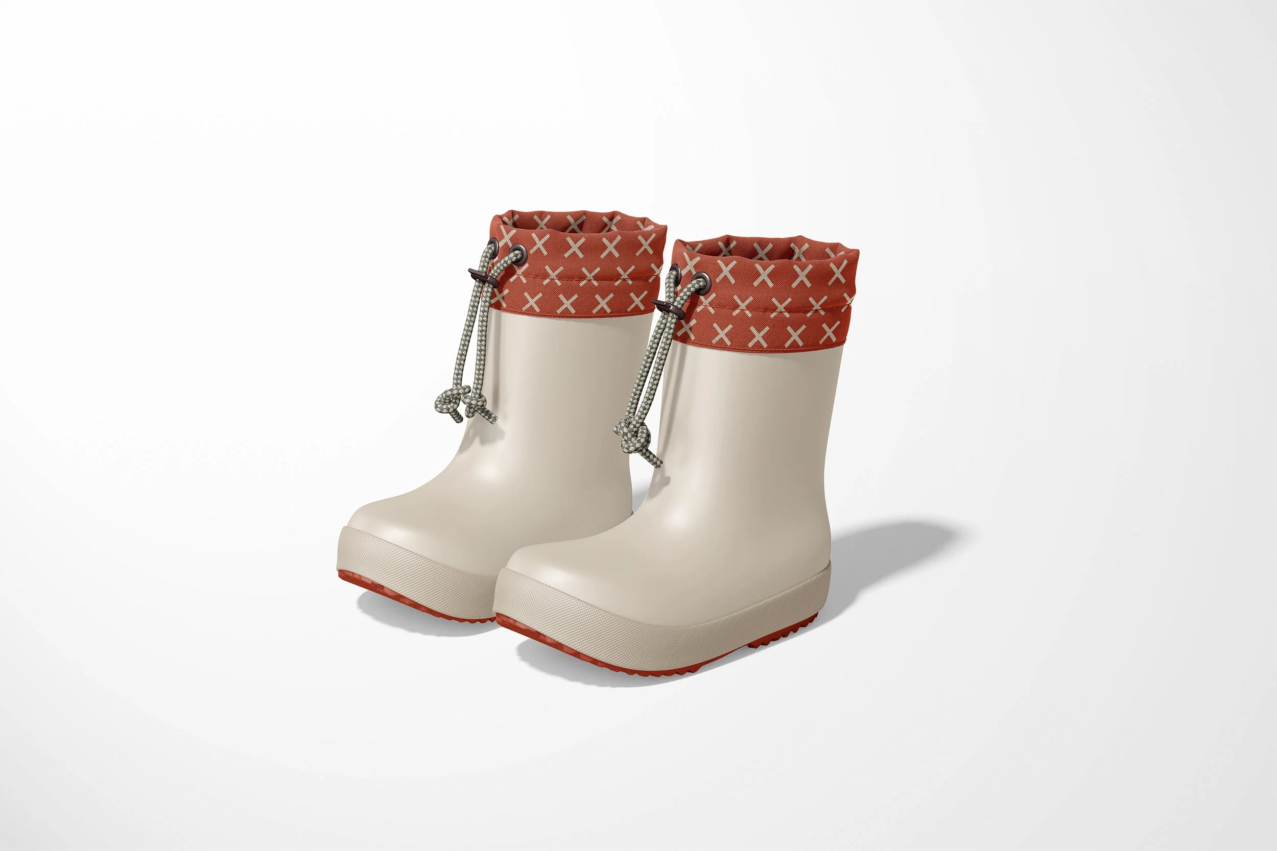 Product shot of cream rain boots with a red and cream patterned lining on a white studio background