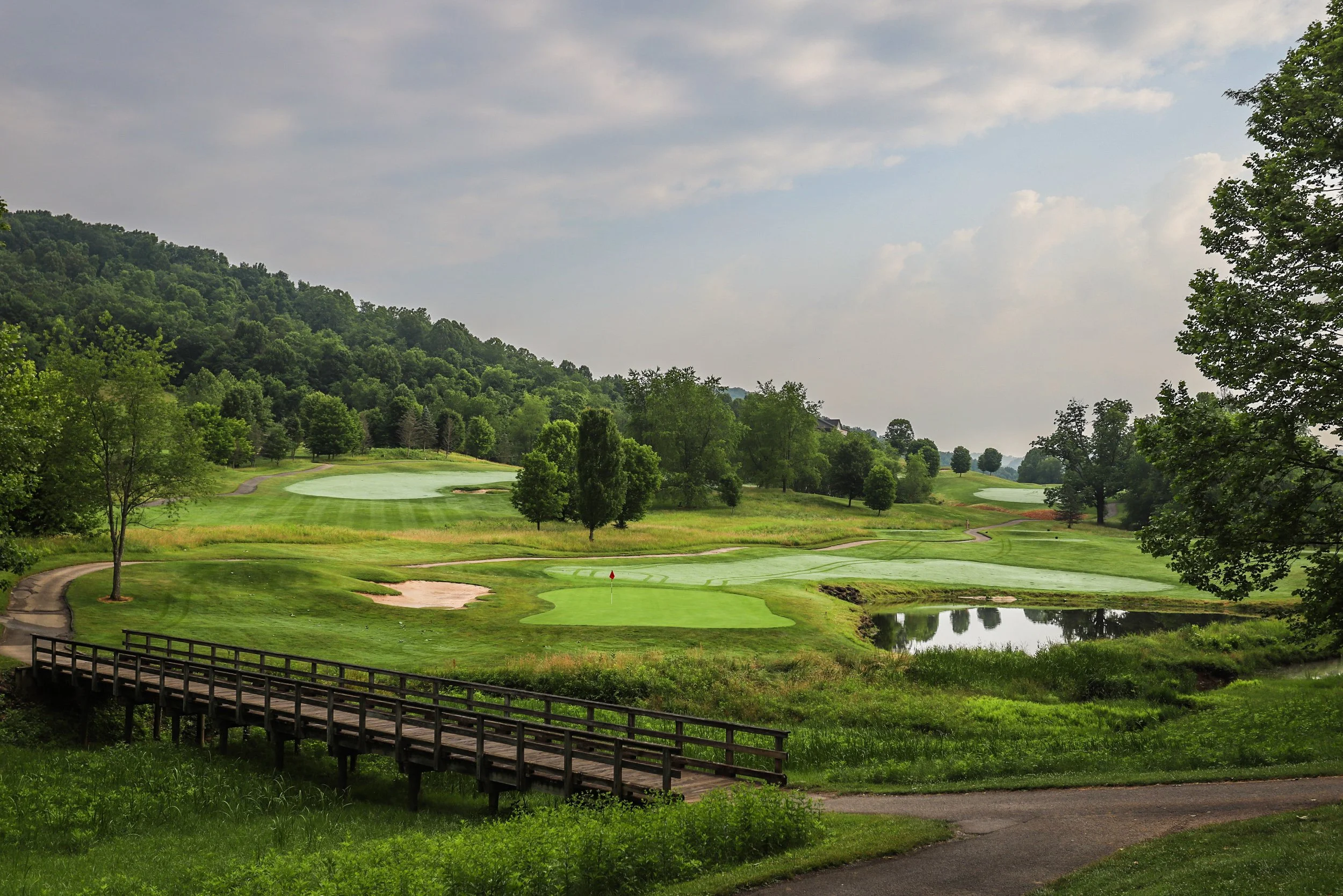 scenic view of golf course and sky