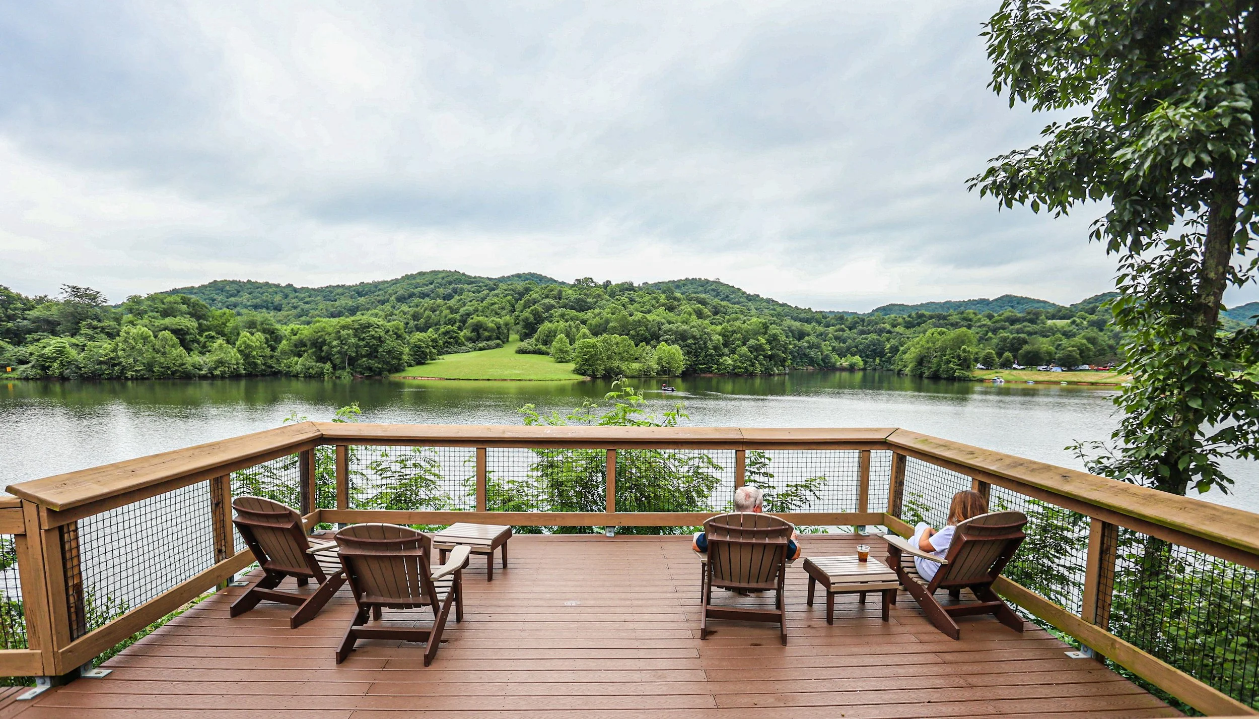 view of Stonewall Lake and deck with Adirondack chairs 