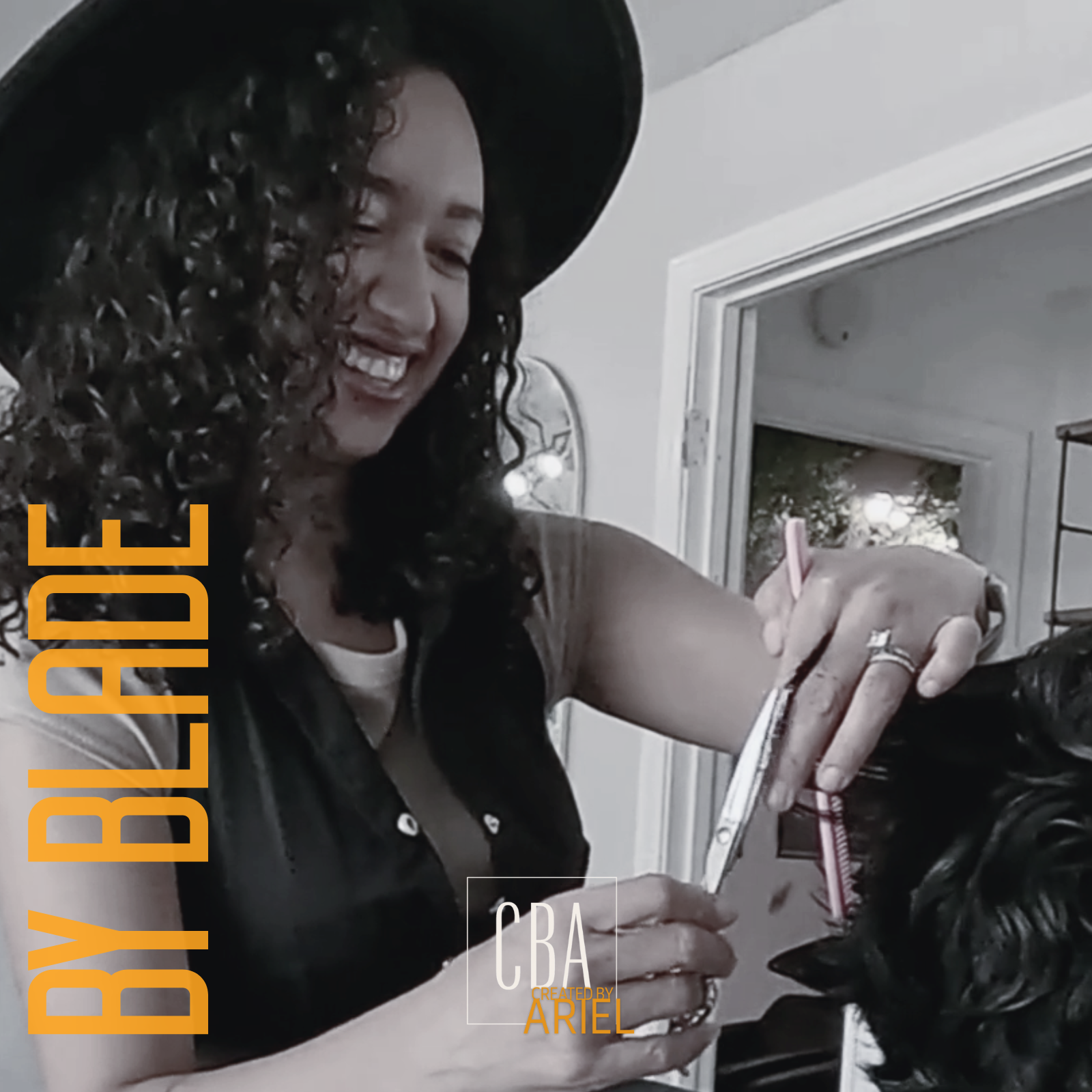 ariel  wearing a black hat smiling while cutting hair Mens MidLength Cut the Mid Muse soft layers Rockwall TX
