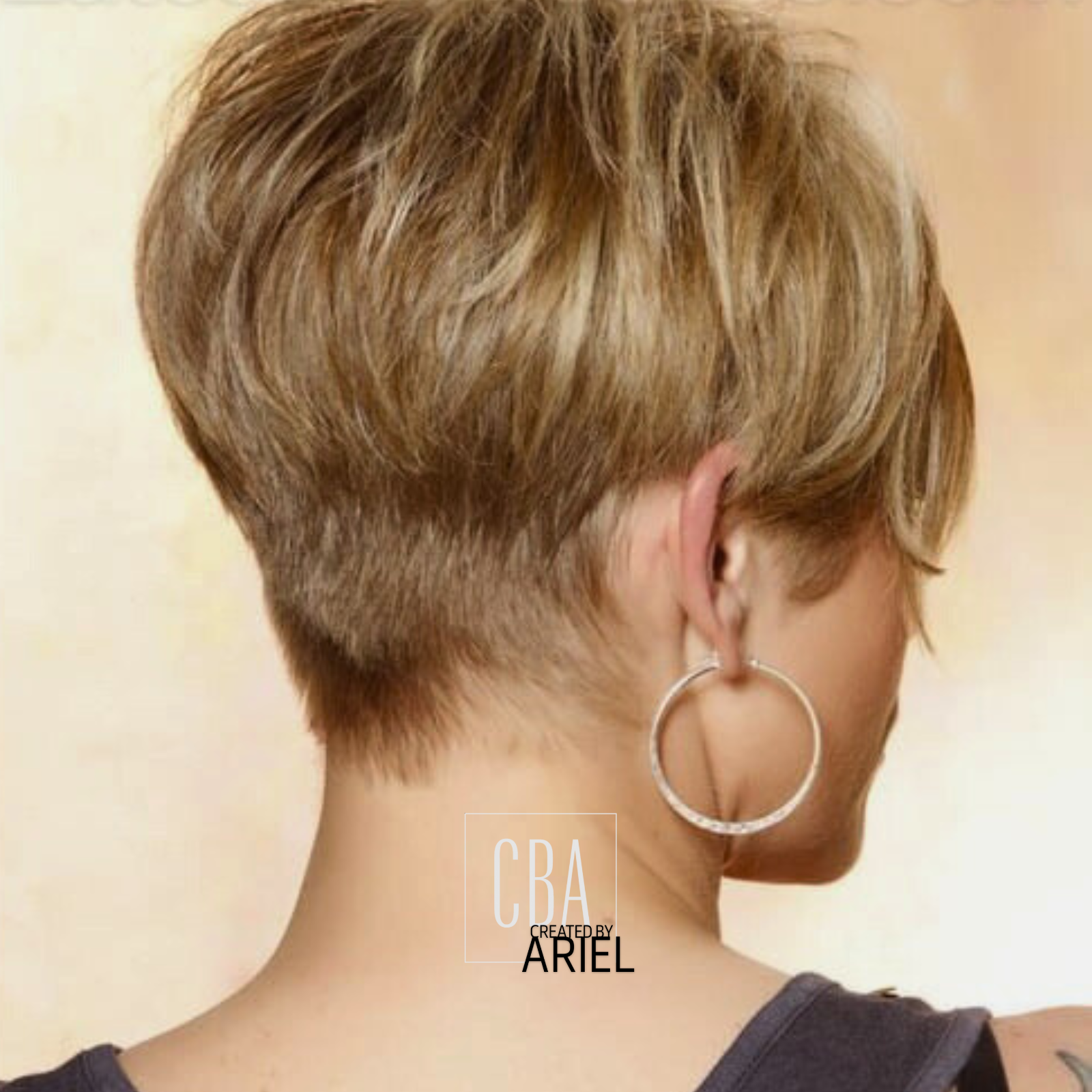 Back view of a woman with short, layered, blonde hair and a large hoop earring, wearing a dark top, against a beige background.