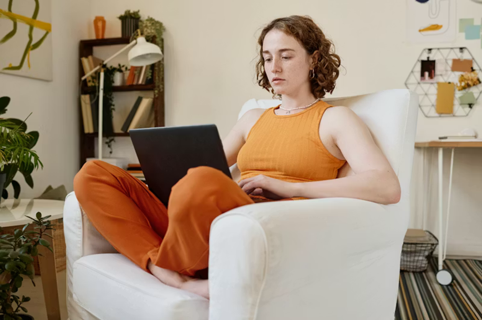woman sitting in chair with laptop
