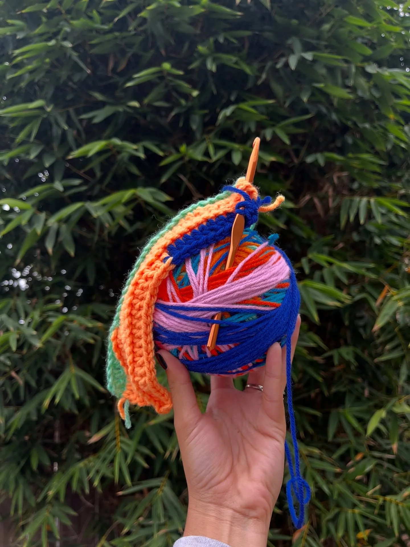 winding and rewinding

i've adopted this new way of creating my scrap yarn beanies - rather than than sitting in a pile of a dozen yarn balls and pulling from each one at will in real time that i am crocheting it, i'm creating a scrap yarn ball to cr