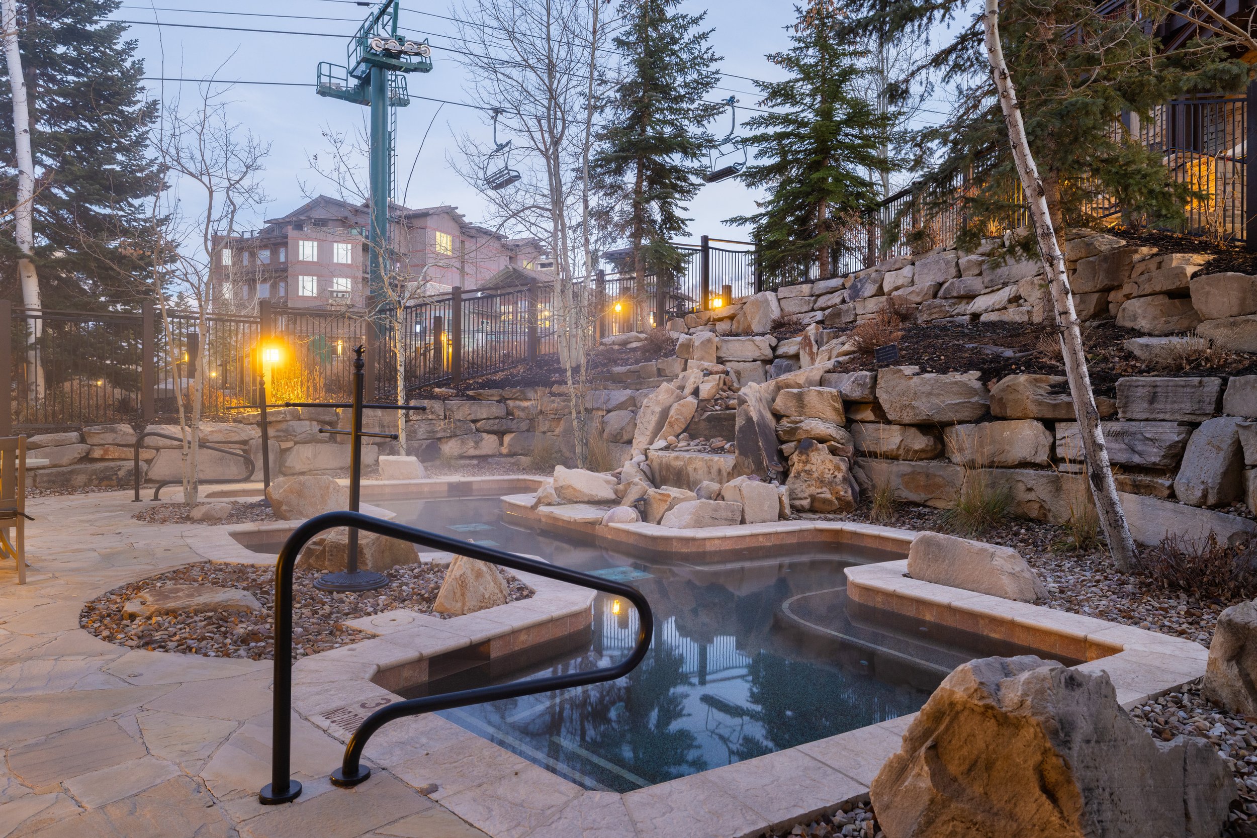 Slope-side hot tub with natural stone surround — the perfect way to end the day