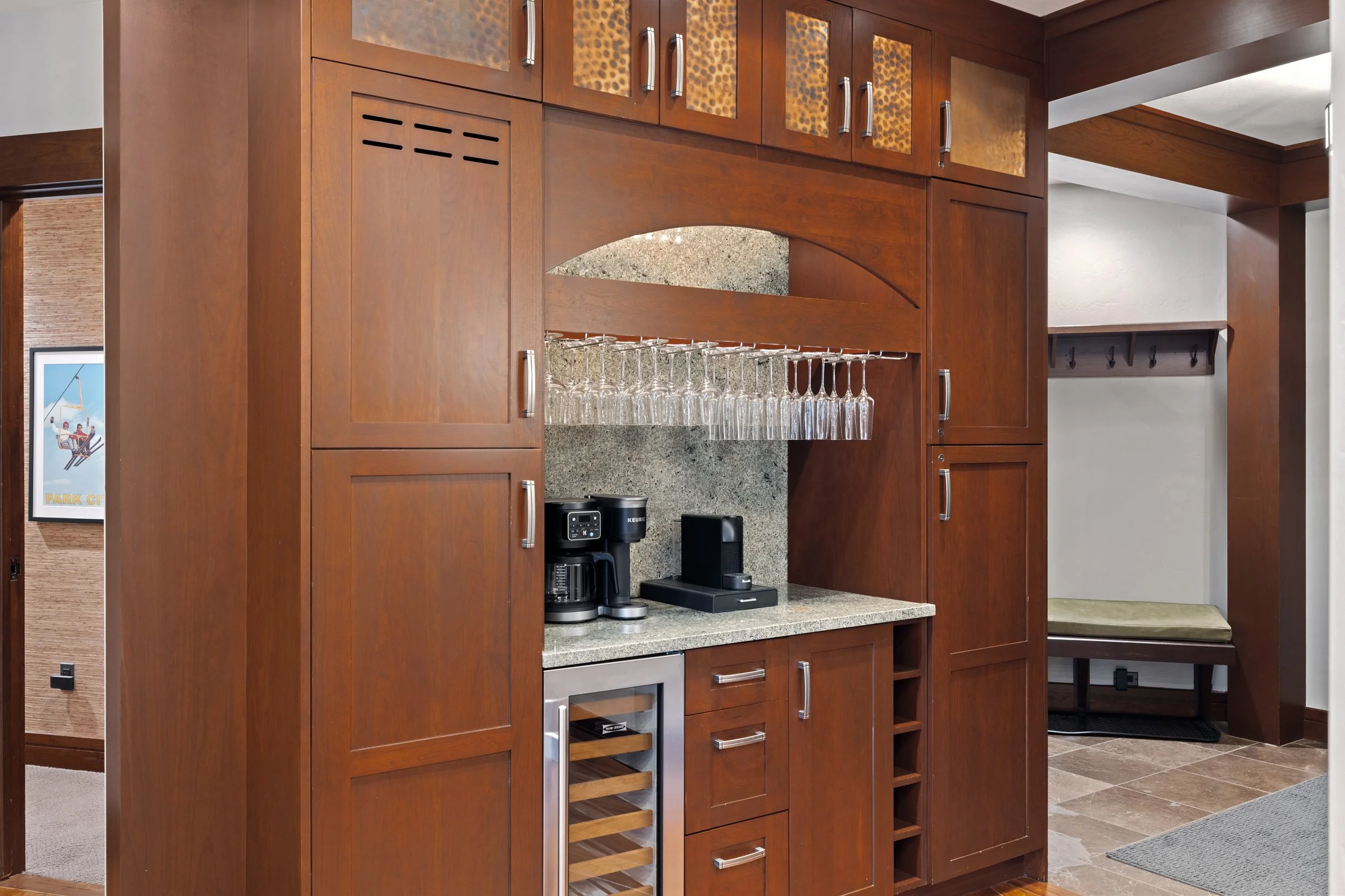 Built-in bar with wine fridge, glassware, and premium coffee station