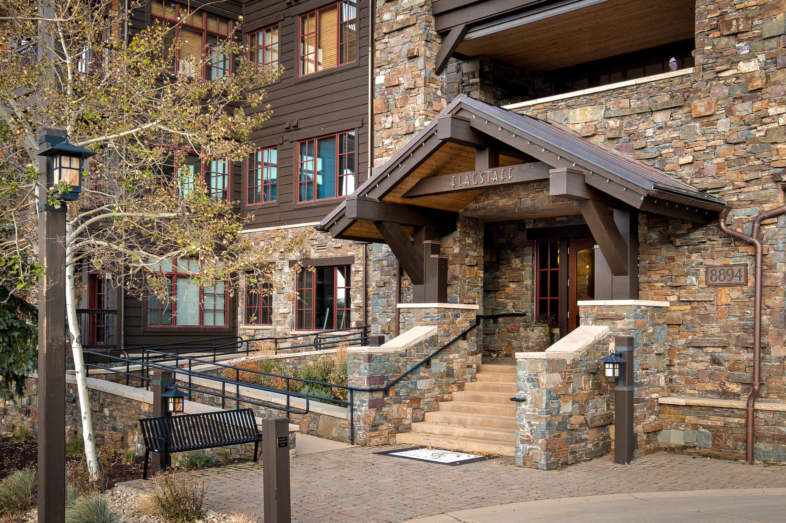 Flagstaff Lodge — stone-and-timber entrance at 8894 Empire Club Drive