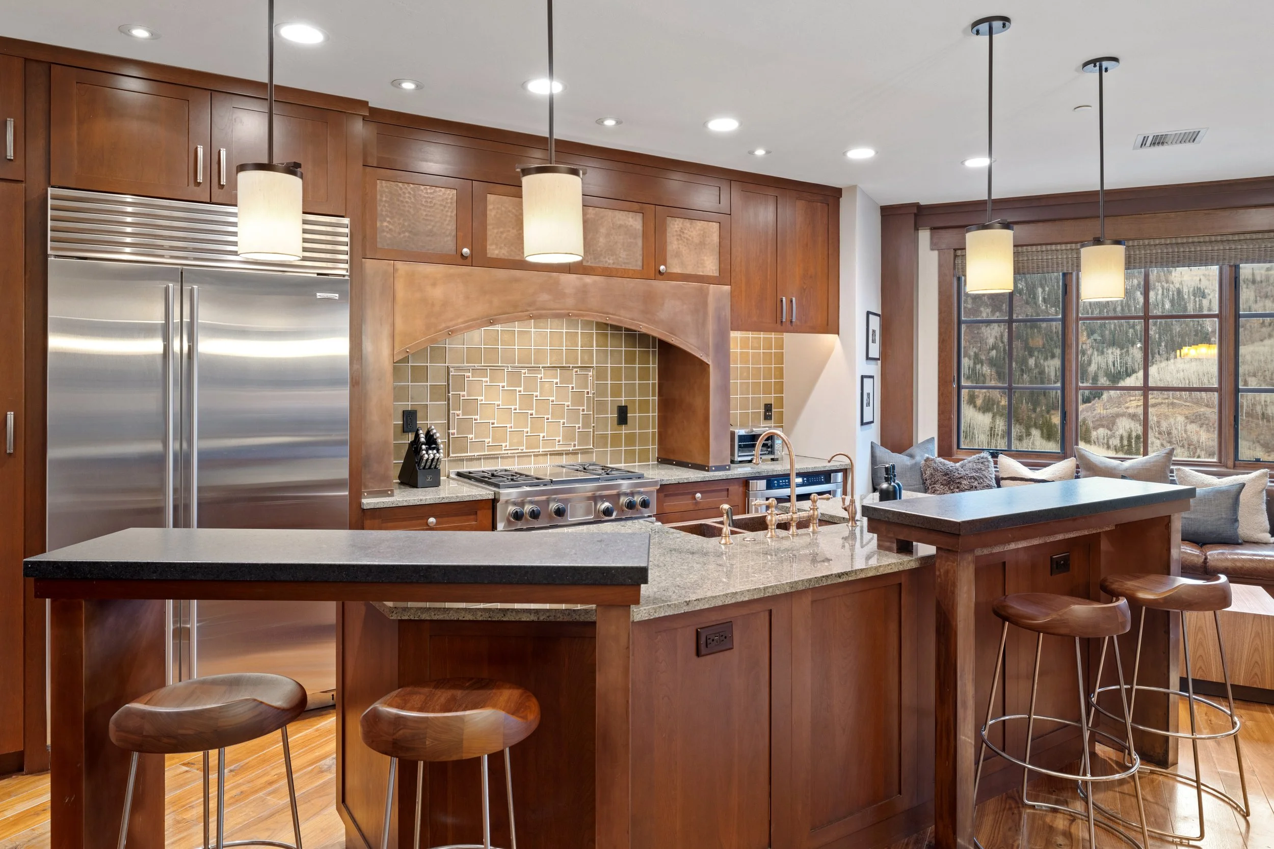 Gourmet kitchen with Sub-Zero refrigerator, professional range, and island seating