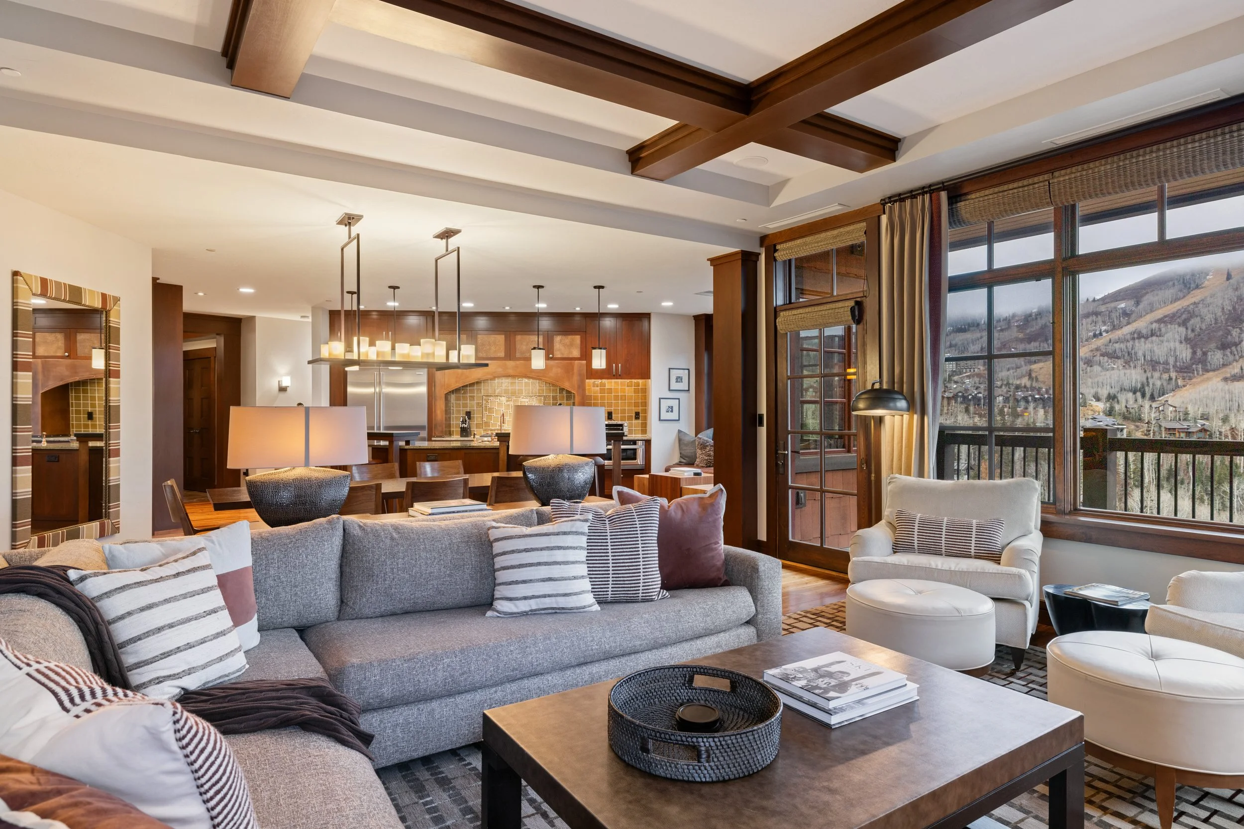 Floor-to-ceiling windows frame sweeping views of the ski runs and Empire Pass