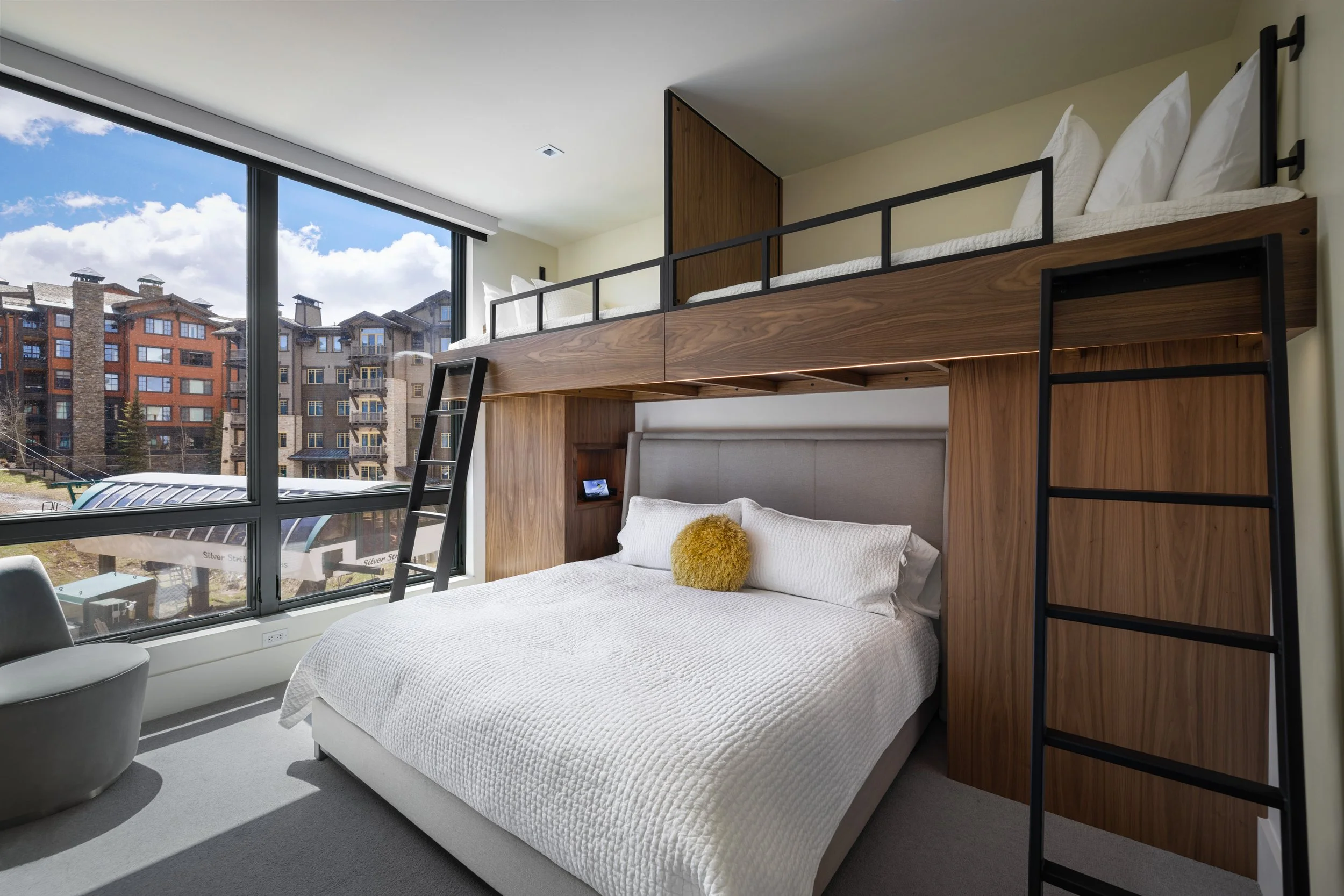 New custom bunk room with king bed below and two twin beds above. Oversized TV and integrated LED lighting.
