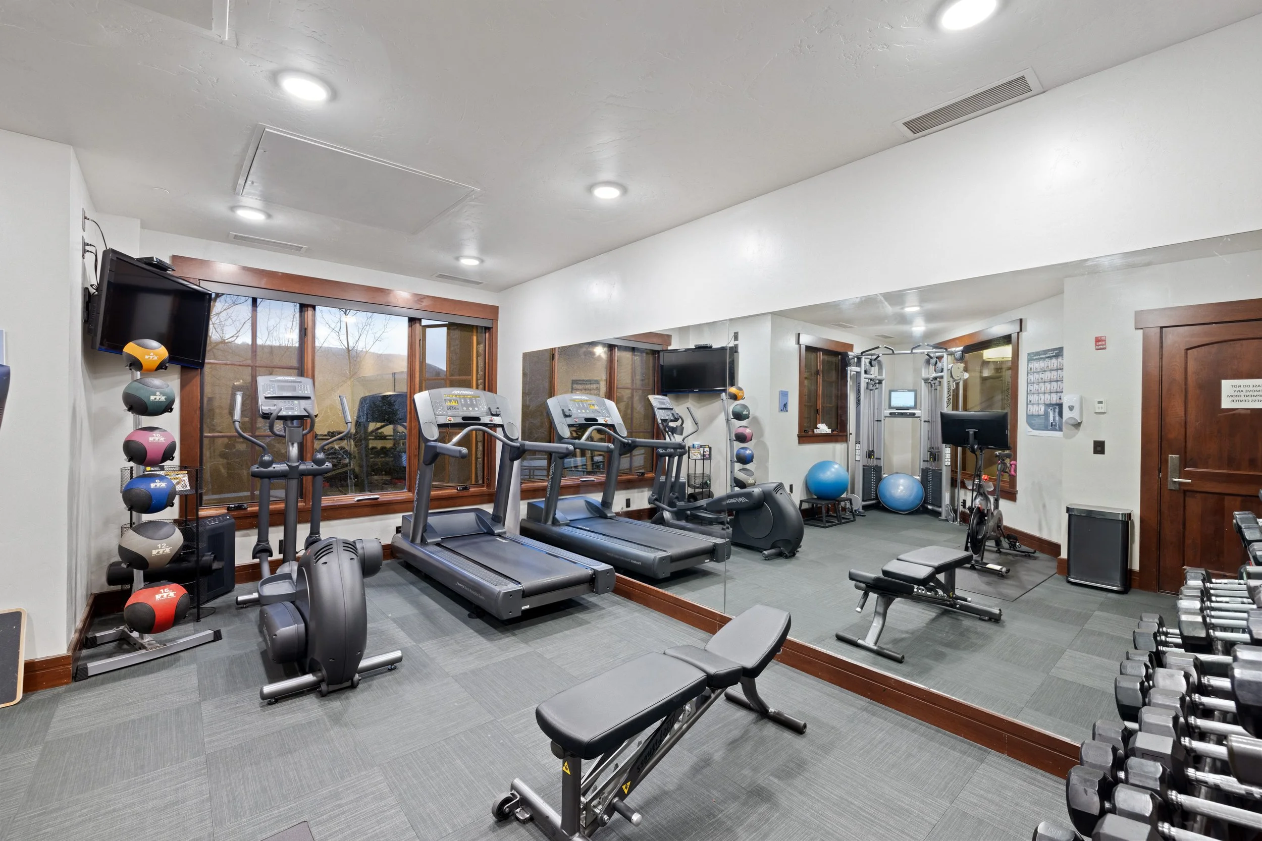 Fitness center with Peloton, treadmills, elliptical, free weights, and more