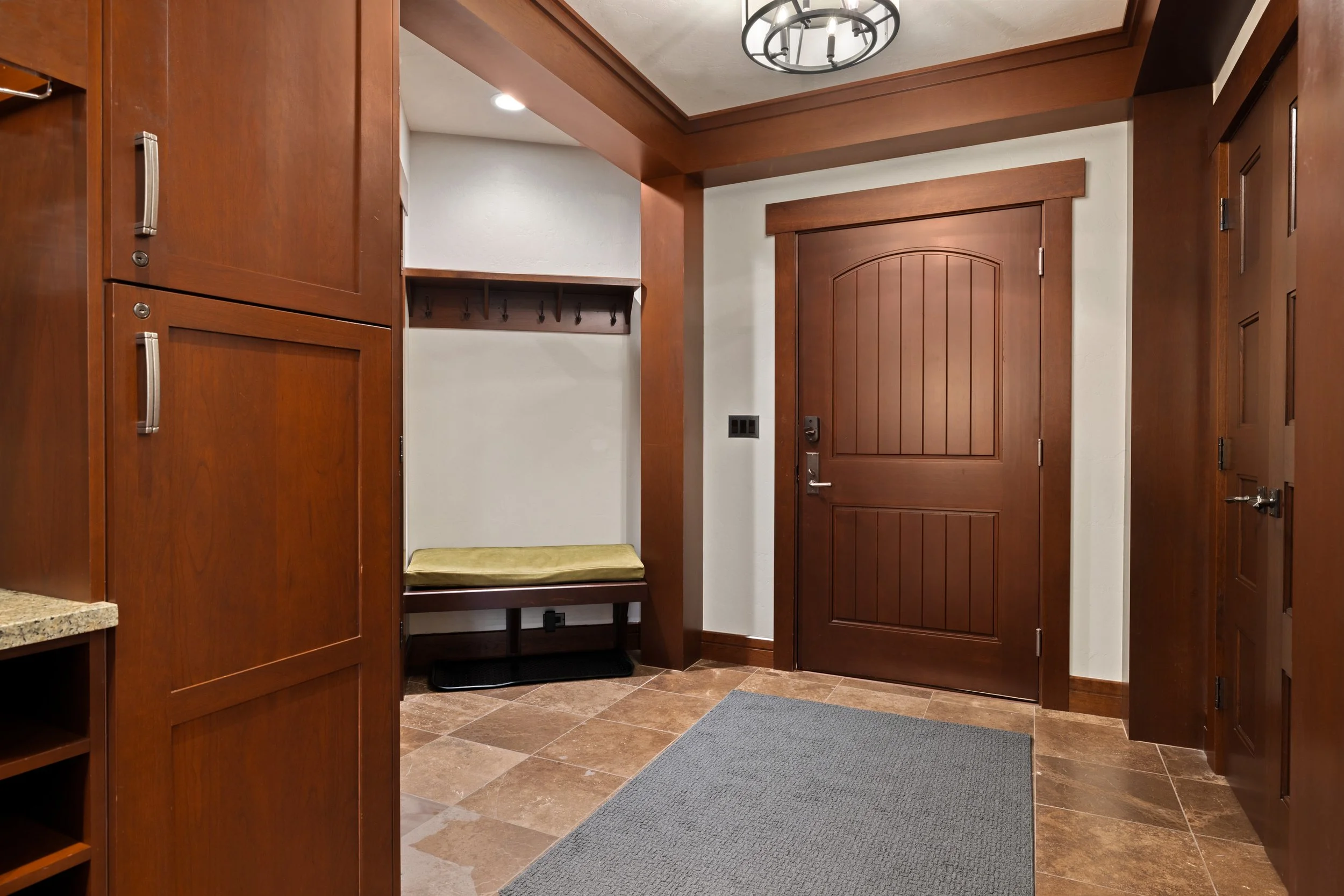Private entry foyer with built-in mudroom bench, hooks, and generous storage