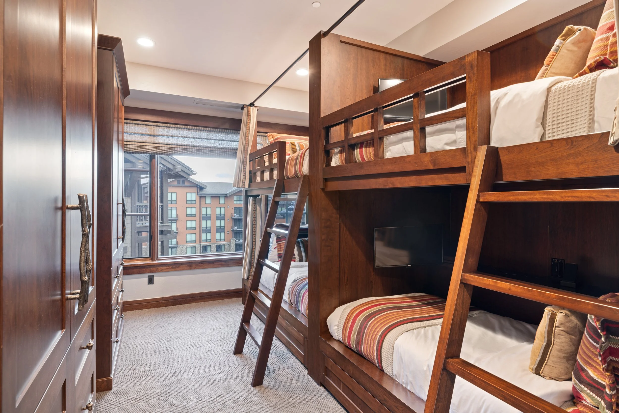 Bunk room with four twin beds, each with its own TV — a favorite with kids