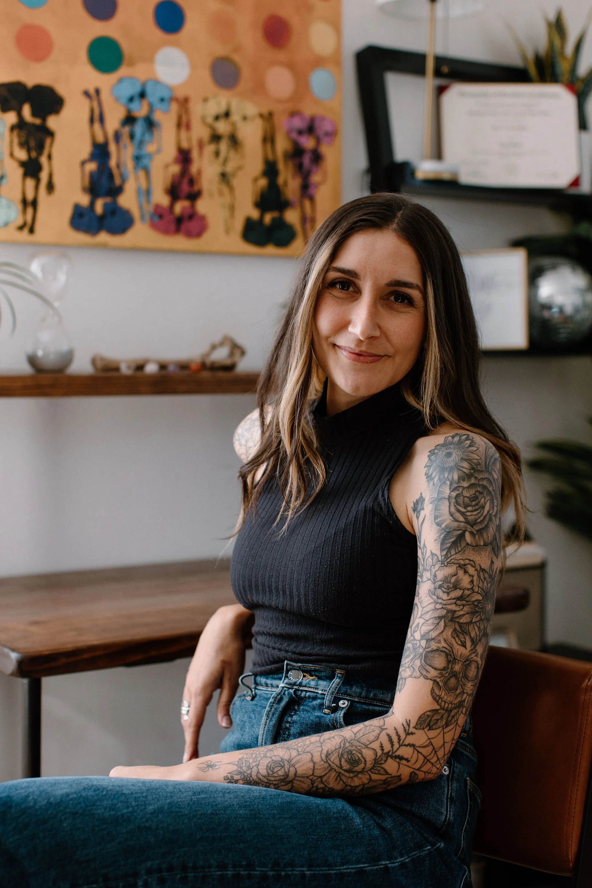 Psychotherapist Eryn Healy, shown with tattoos down one arm, helps Gen Z people and others deal with stress / distress, limiting beliefs, shame, anxiety, and attitudes that hold you back.
