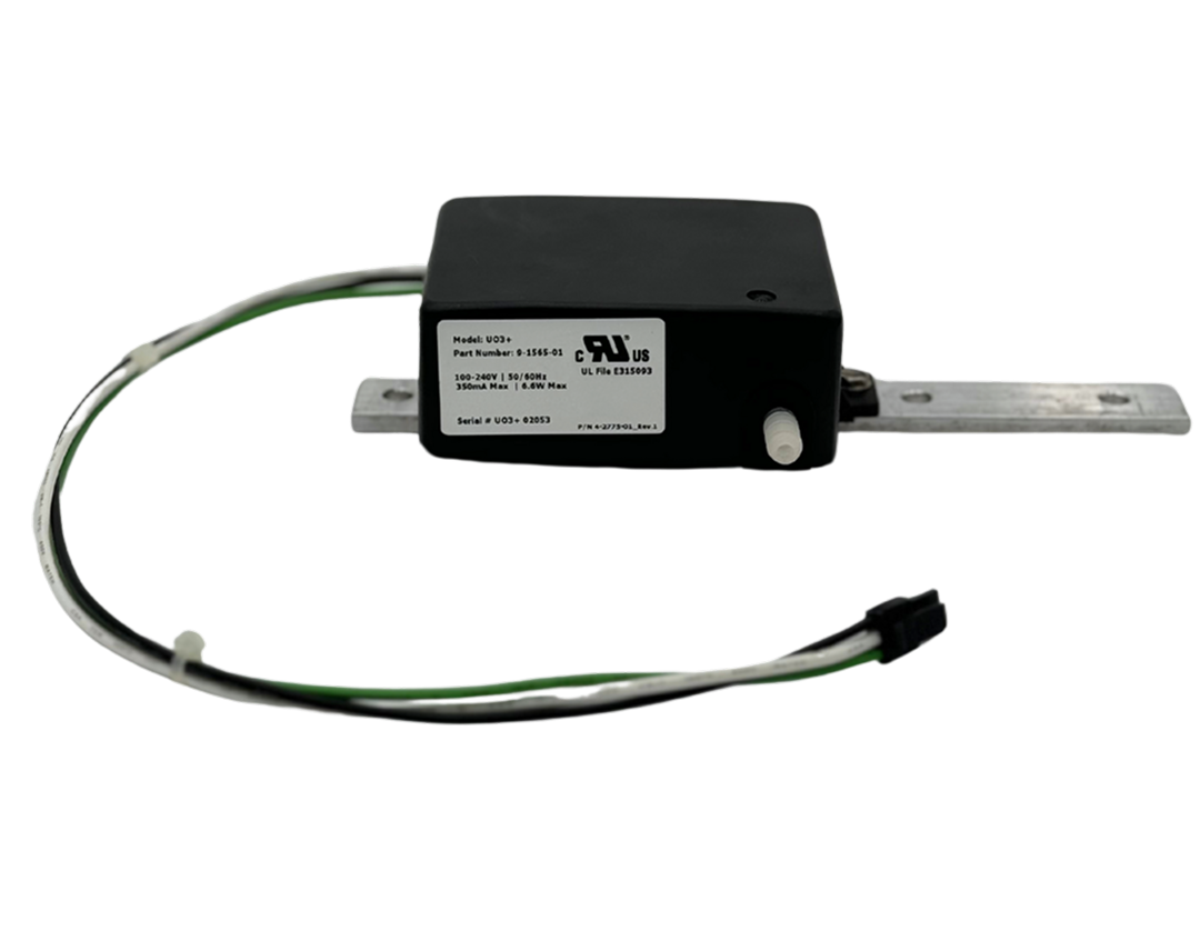 A black electronic device with wires attached, labeled with technical specifications, and mounted on a metal rail.