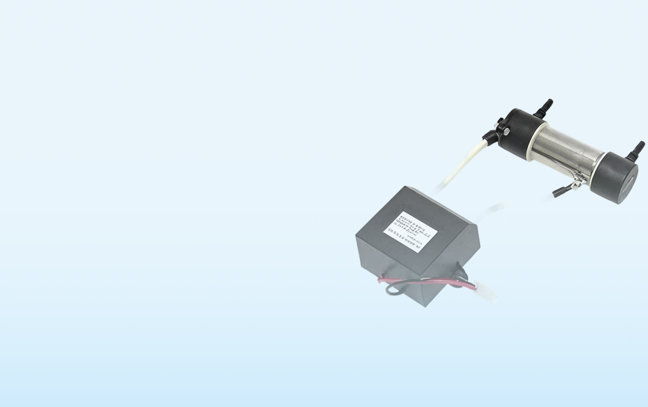 A cylindrical metal device connected to a black box with wires, set against a light blue background.