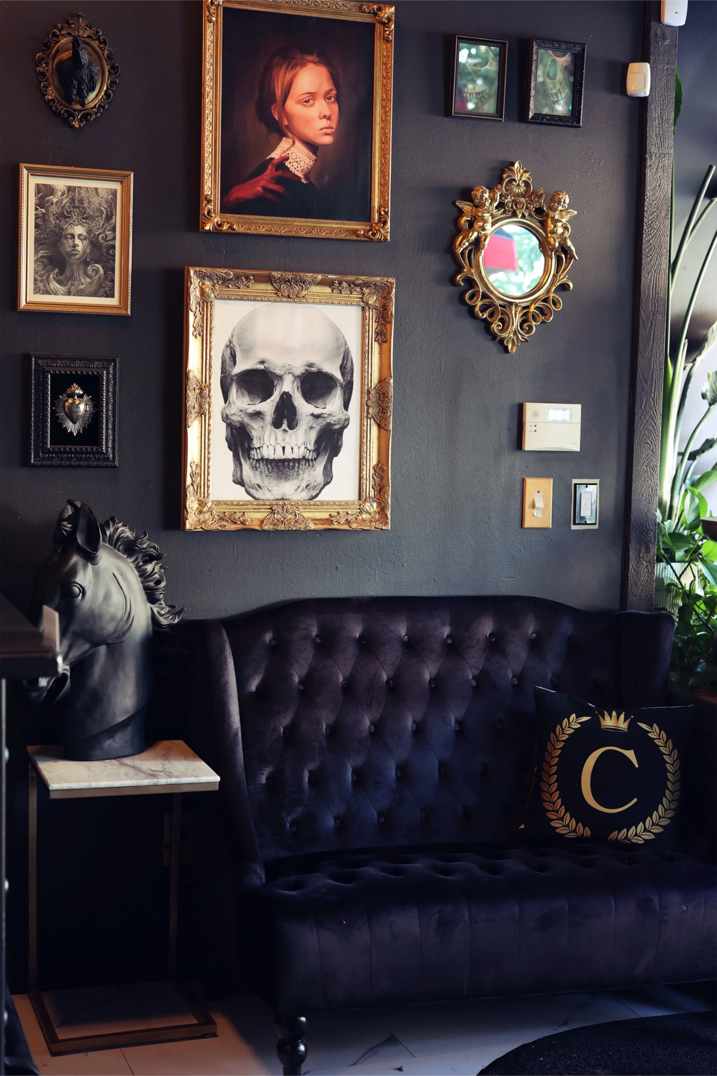 The lobby has a luxurious and slightly gothic aesthetic, featuring hand drawn charcoal drawings similar to the black and gray realism tattooing provided at the shop. This Boise lobby is decorated heavily with quality art and superior design. 