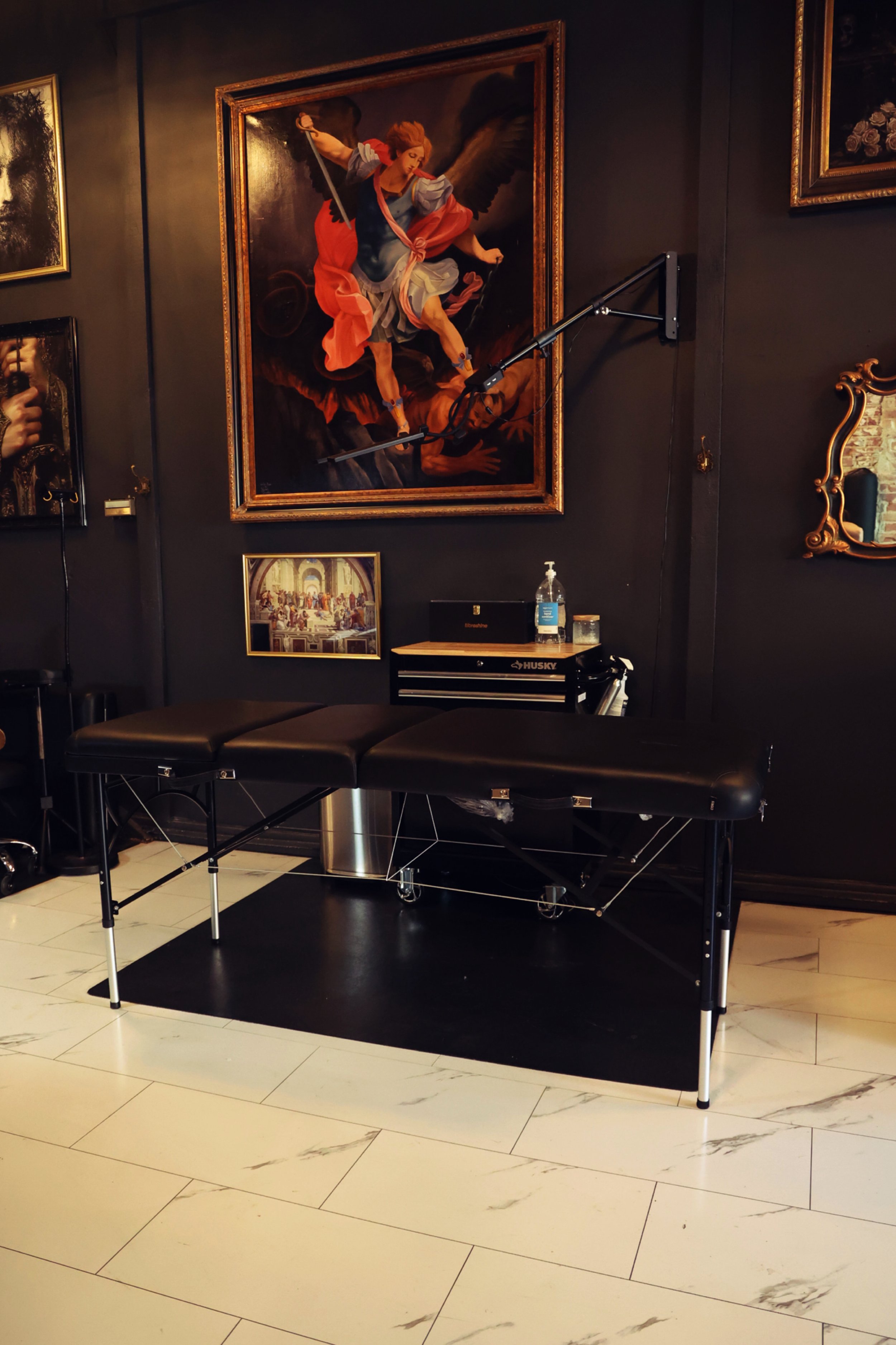 Large original hand-painted oil paintings span the walls and have been collected from noteworthy artists and tattooers and framed for an epic display. 