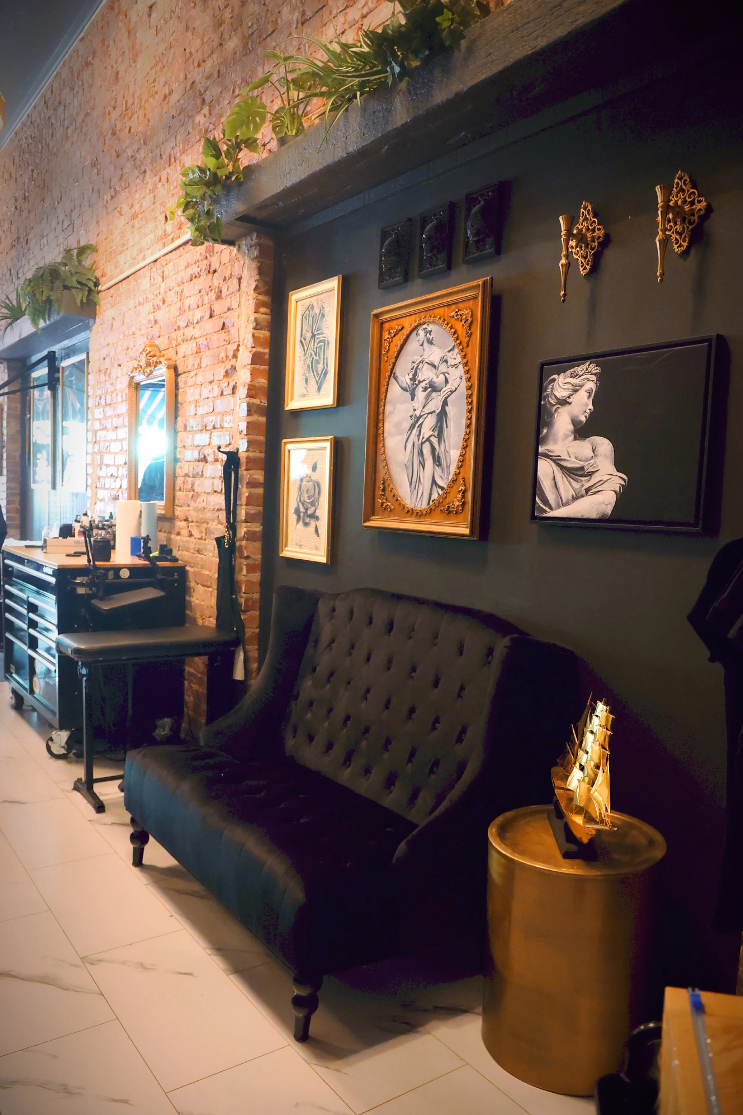 A cozy interior featuring black velvet sofas and gold end tables make this Boise lobby a comfortable and sexy place to sit while your artist works to get your design ready to tattoo. 