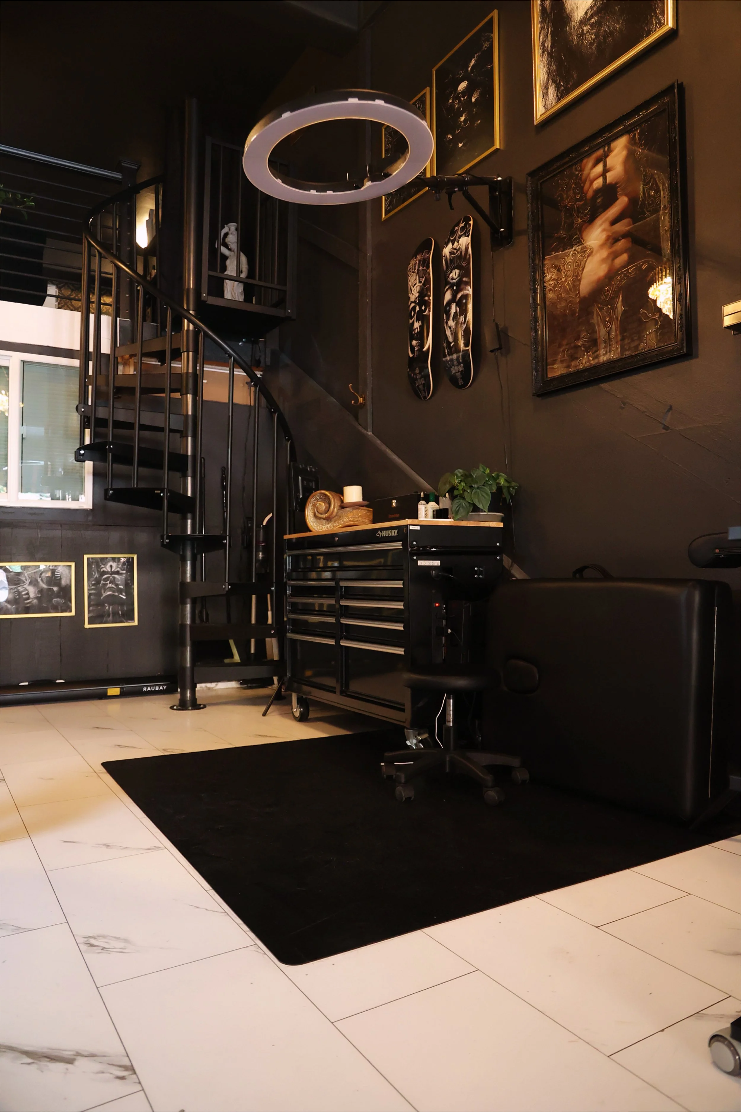 Tattoo stations are clean and organized with mounted ring lights and state-of-the-art black and gold themed furniture for maximum client comfort.