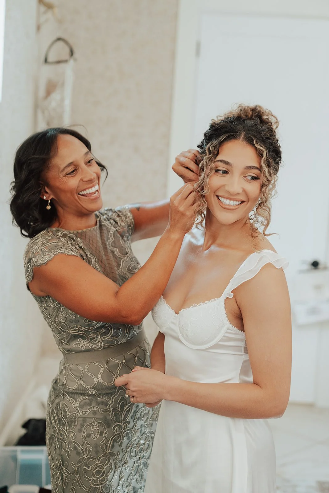 A bride and her mother getting ready for the wedding ceremony - photography by Poise and Ivy Imagery