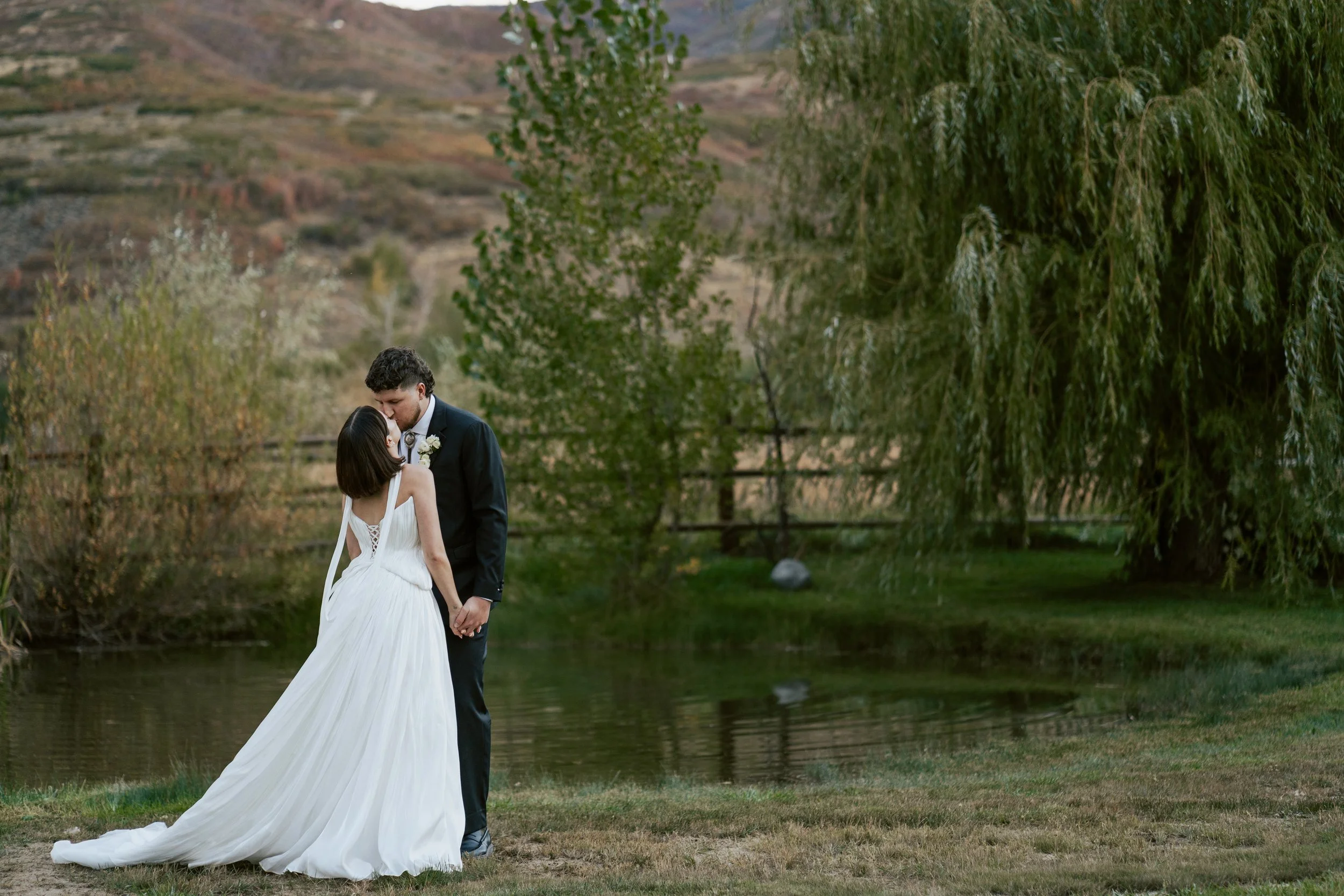 bride and groom embrace during their wedding reception at a private ranch in Salt Lake City Utah during a wedding photographed by poise and ivy imagery