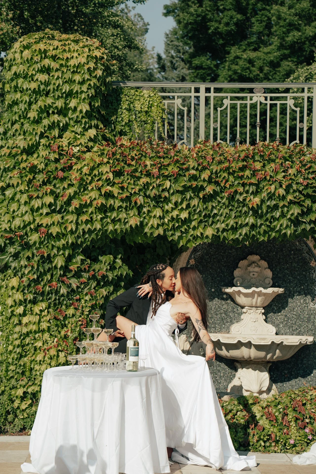 two brides celebrate their marriage with a champagne pour - Poise and Ivy Imagery