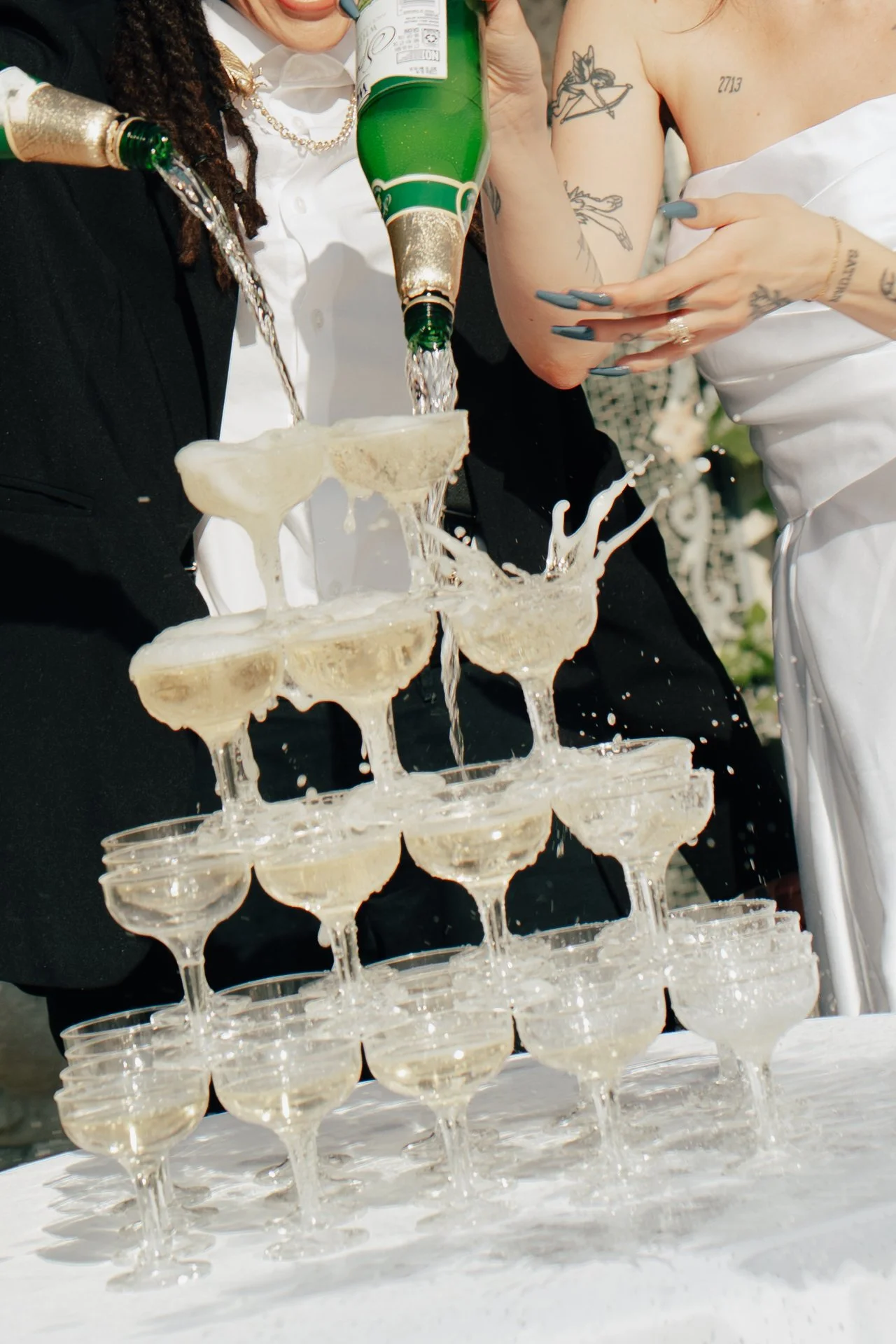 two brides celebrate their marriage with a champagne pour - Poise and Ivy Imagery
