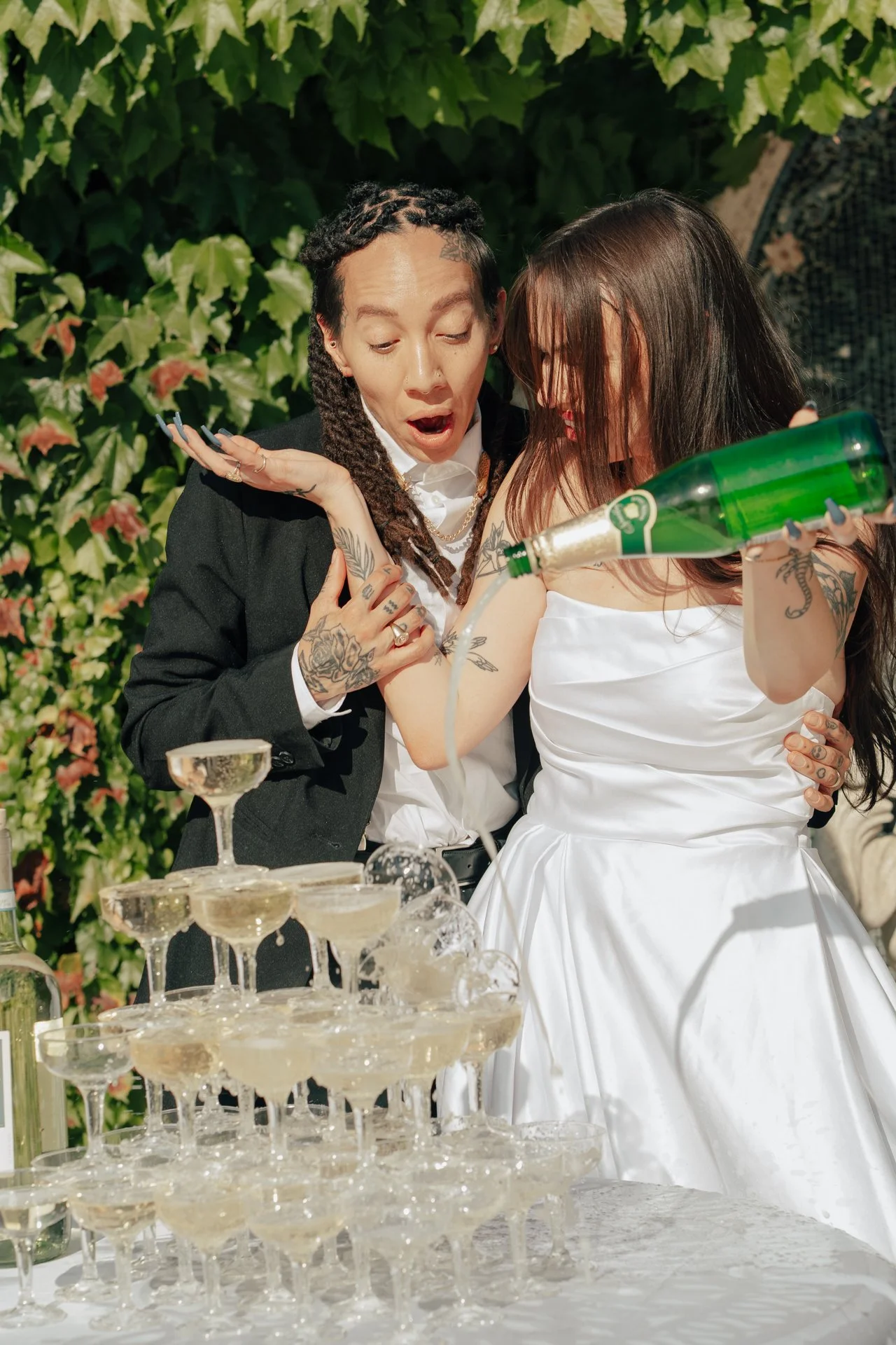 two brides celebrate their marriage with a champagne pour - Poise and Ivy Imagery