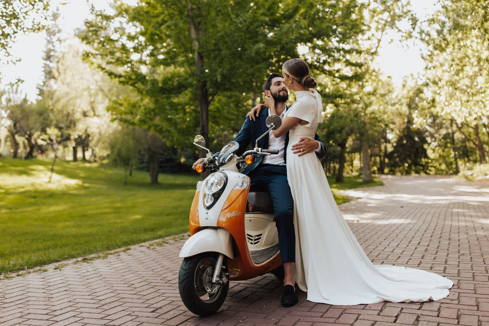 Bride and groom pose with a vespa at Salt Lake City wedding venue La Caille, captured by wedding day photographer Poise & Ivy Imagery