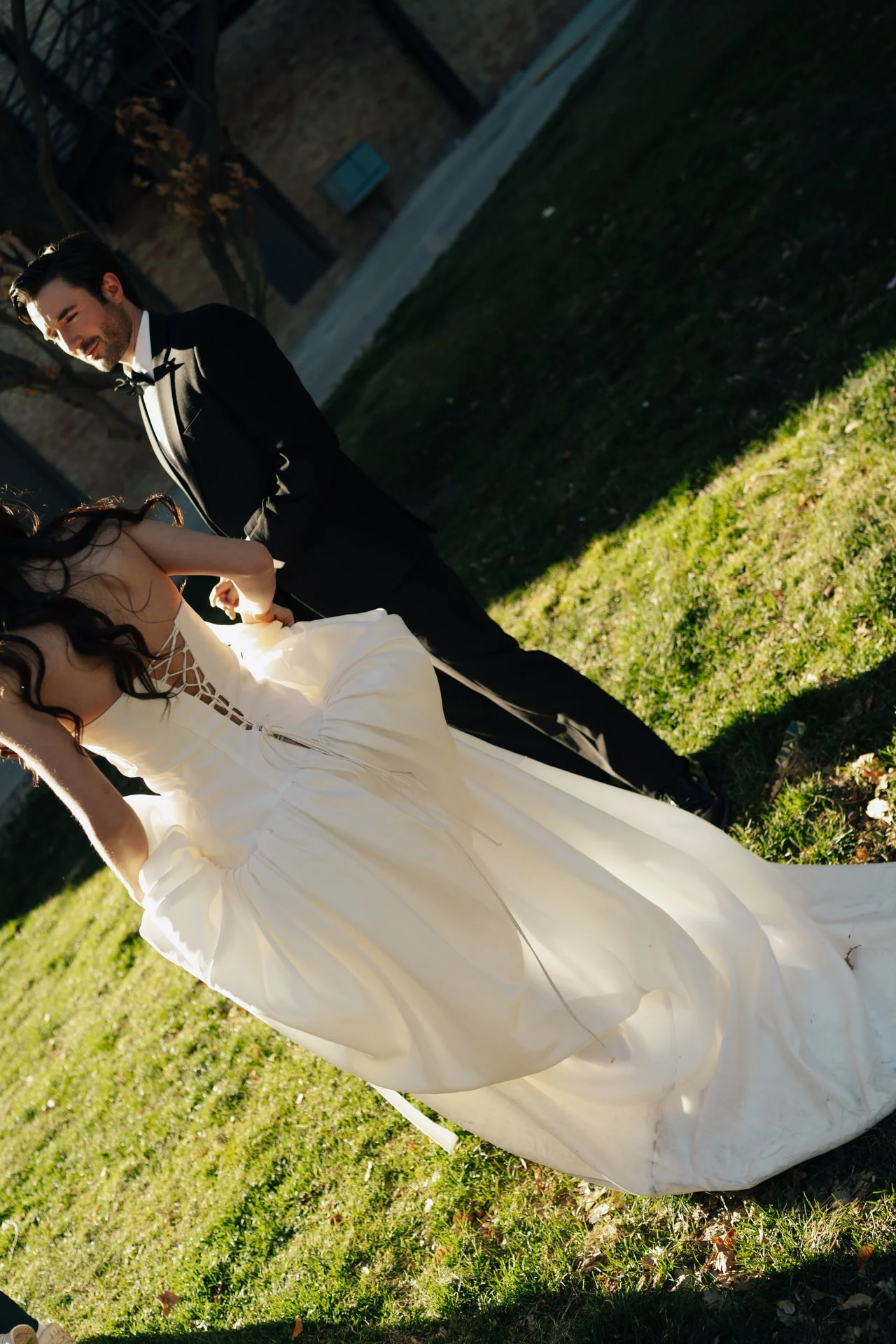 Bride and Groom in classic elegant wedding attire surrounded by beautiful stonework architecture during a downtown formals photoshoot - Poise and Ivy Imagery
