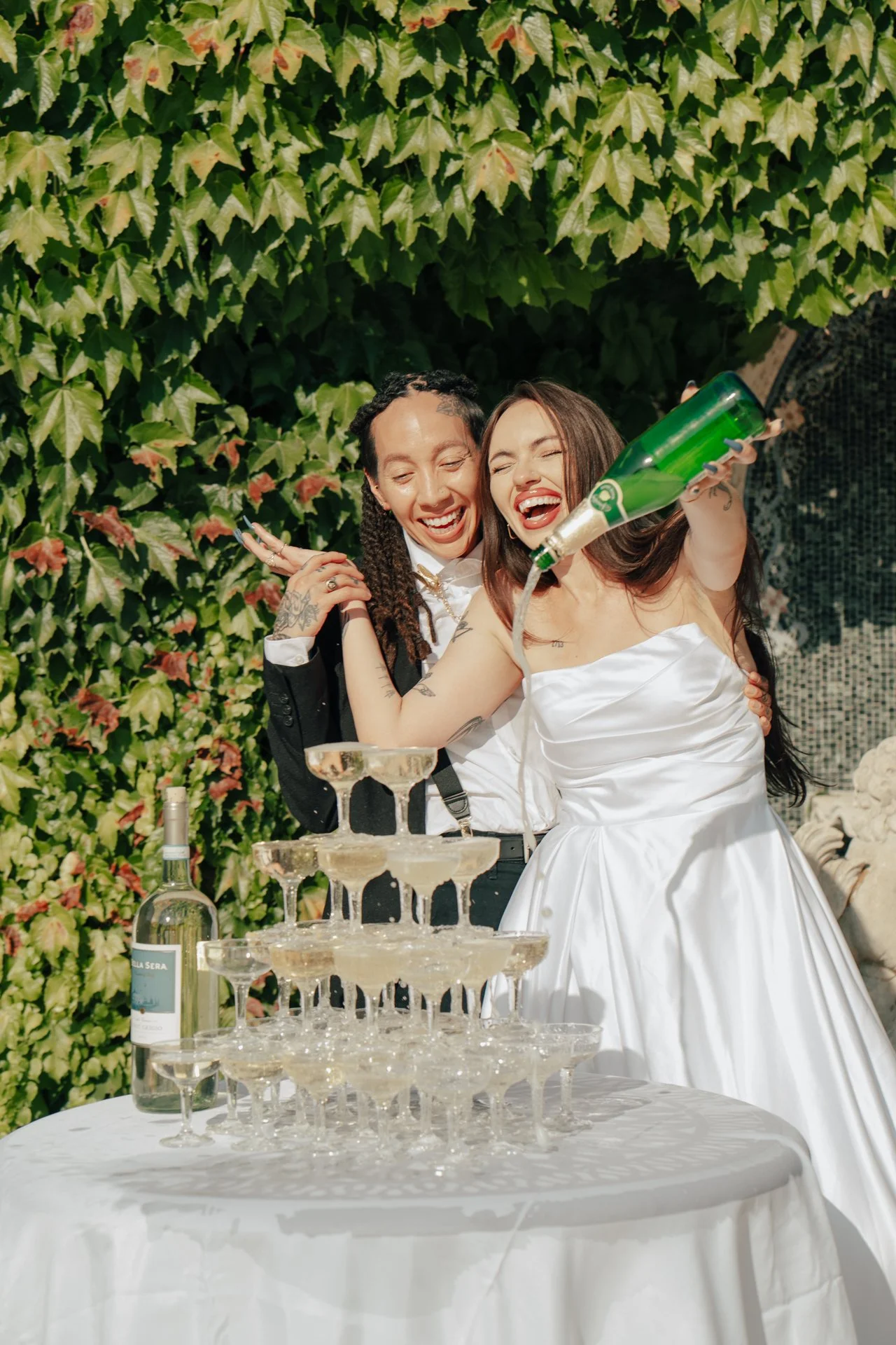 two brides celebrate their marriage with a champagne pour - Poise and Ivy Imagery