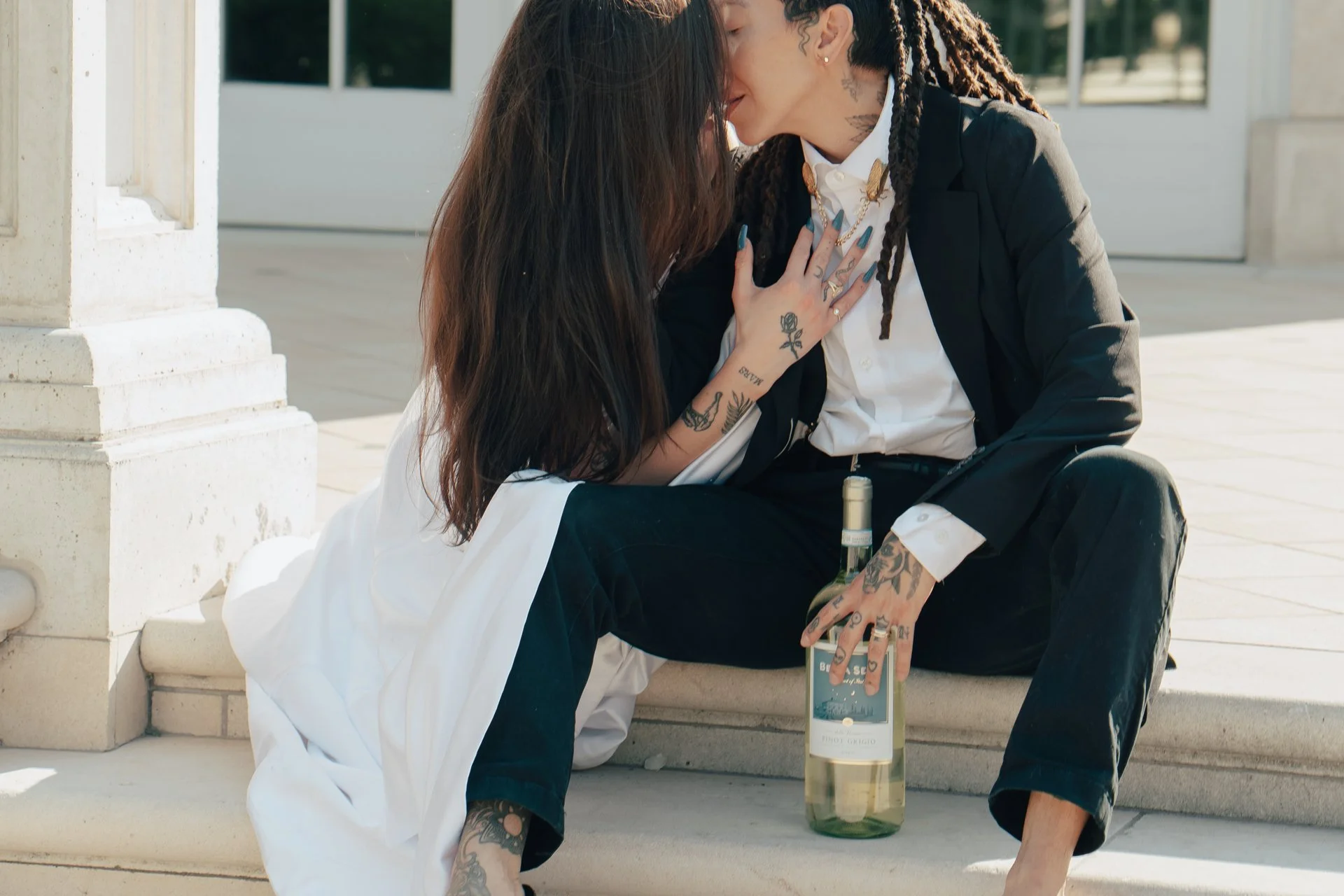 two brides embrace each other dressed in their wedding attire - photographed by Poise and Ivy Imagery