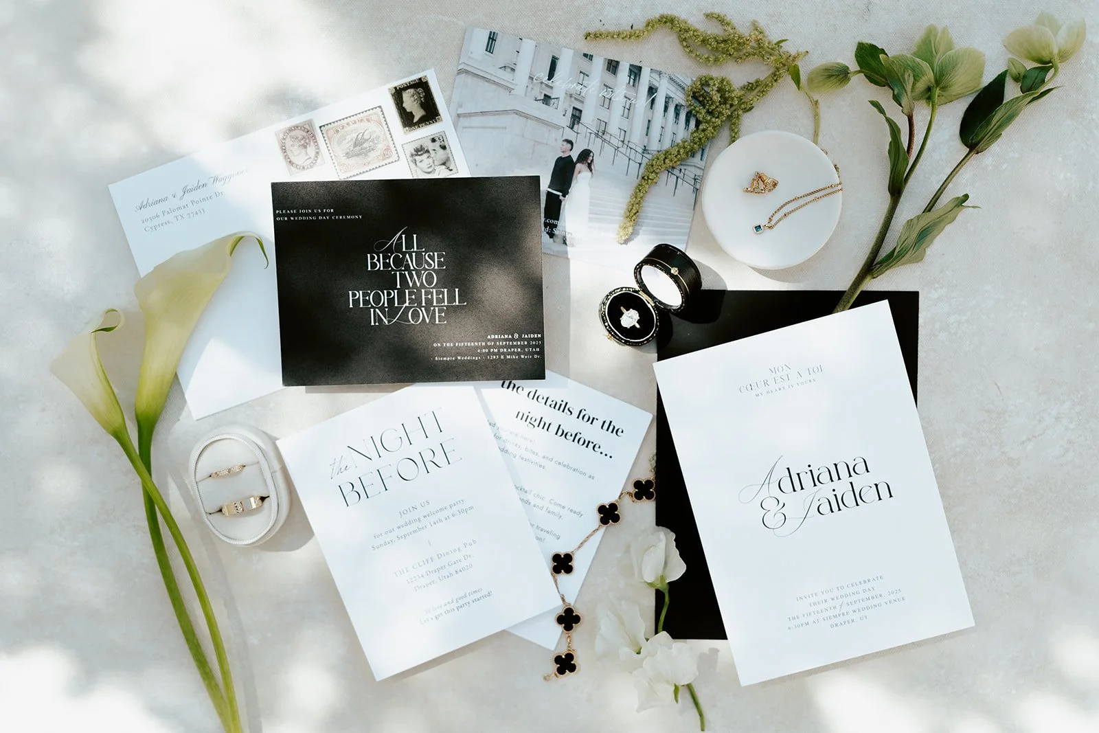 elegant black and white wedding invitation suite, wedding rings in a white ring box, and calla lilies and amaranth displayed - photo by Poise and Ivy Imagery