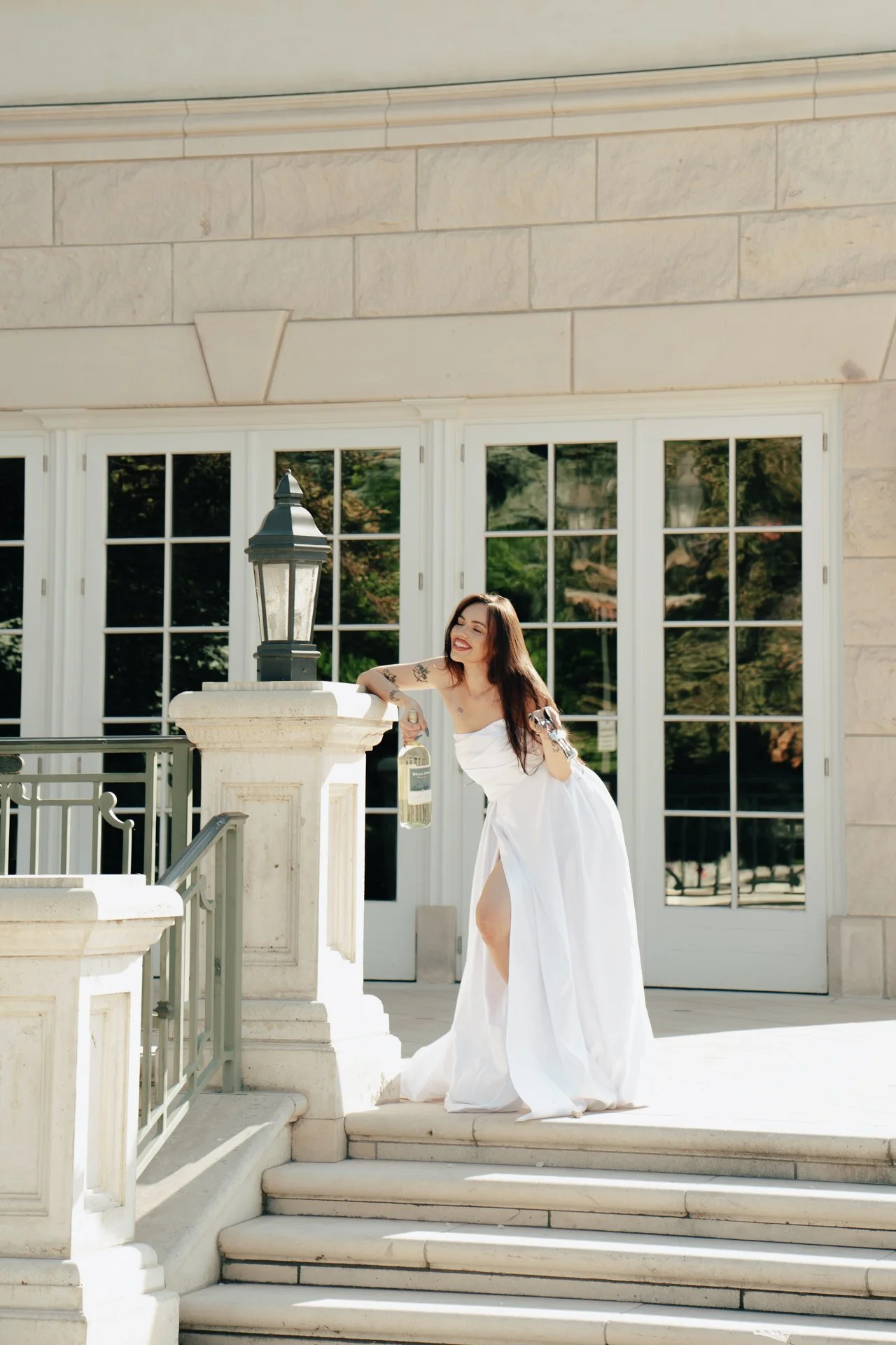 a bride spins in her wedding dress in an ornate foyer - photographed by Poise and Ivy Imagery