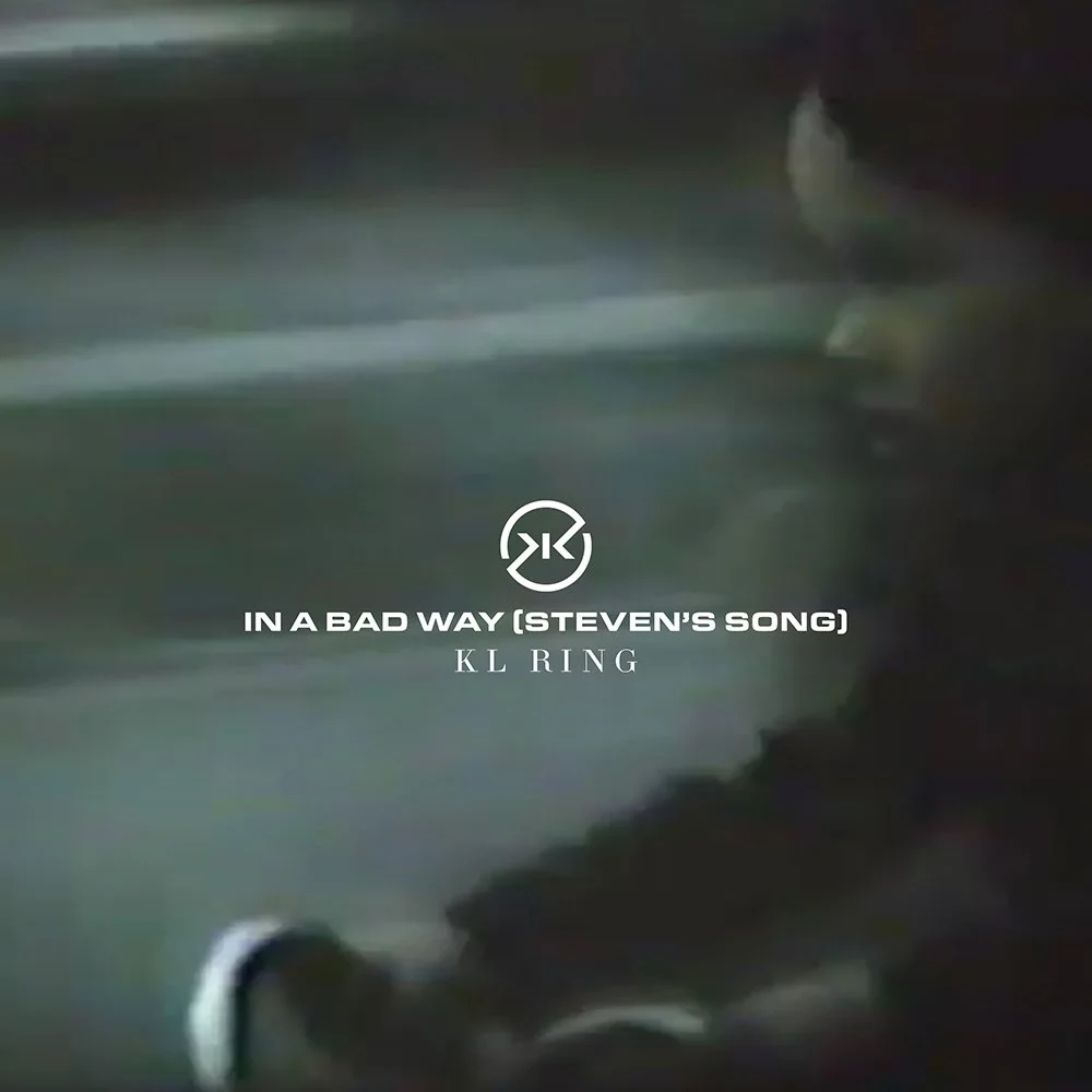 Music album cover with the title 'In a Bad Way (Steven's Song)' by KL RING, featuring a close-up image of someone riding a bike. The image is pixelated, with dark and muted colors. It is a still from home movies footage.
