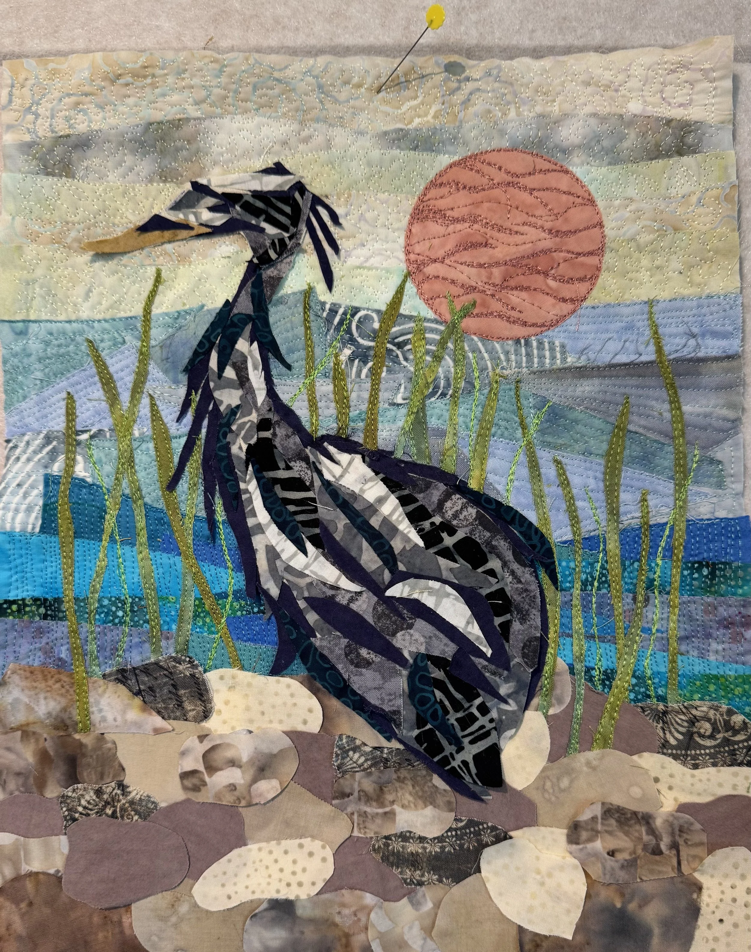 Peggy Epton - “Stillness” - 12”x15” - Fiber: fabric and thread - The heron centers on patience, grace, and independence. It is often symbolizes a meditative approach to life’s challenges. - $425 