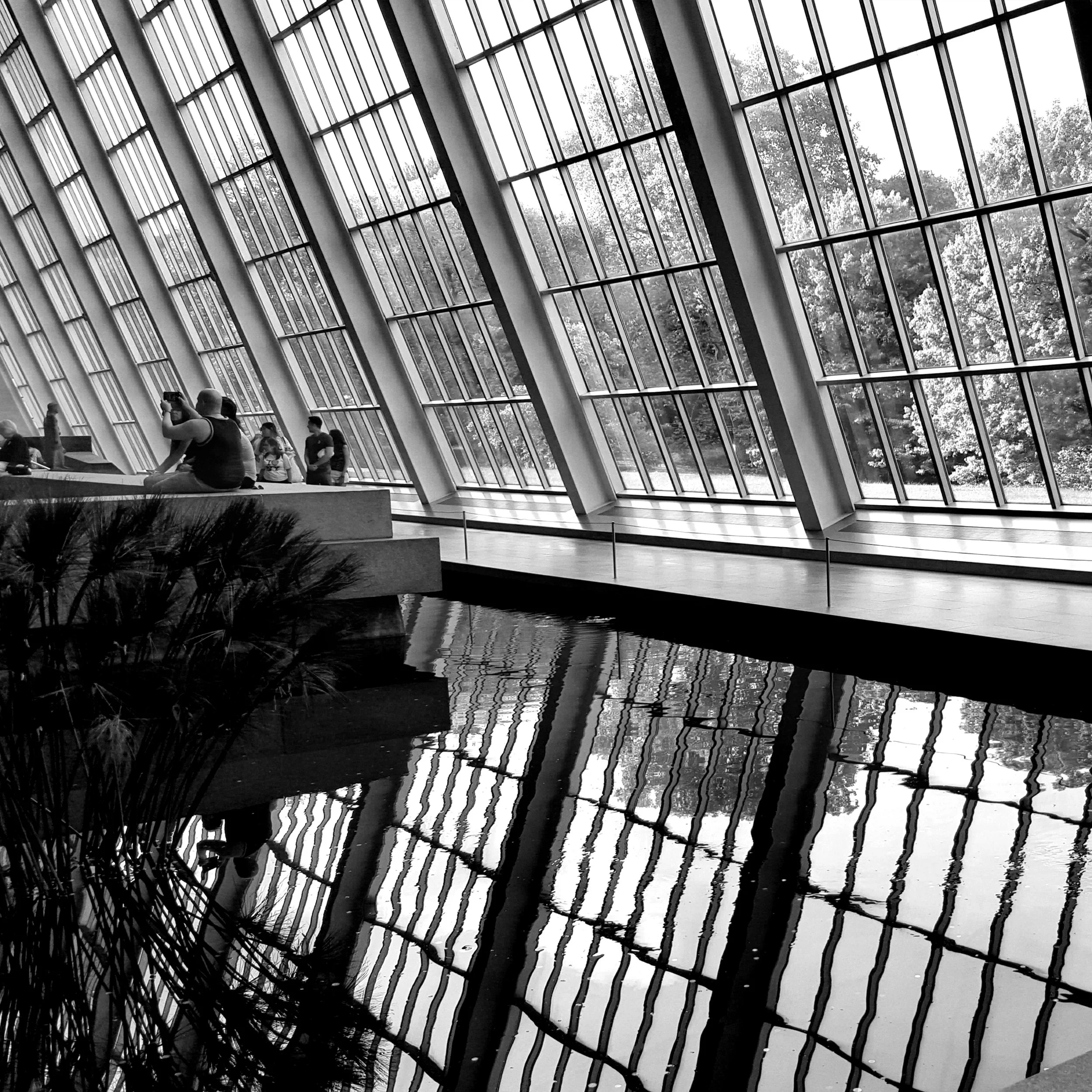 Denise Dell'Olio; Angular Serenity; Photography; At the Met, the water’s reflection mirrors the rigid architecture, creating a rhythmic dialogue between the solid structure and its fluid, liquid twin to bridge the two worlds.; $650