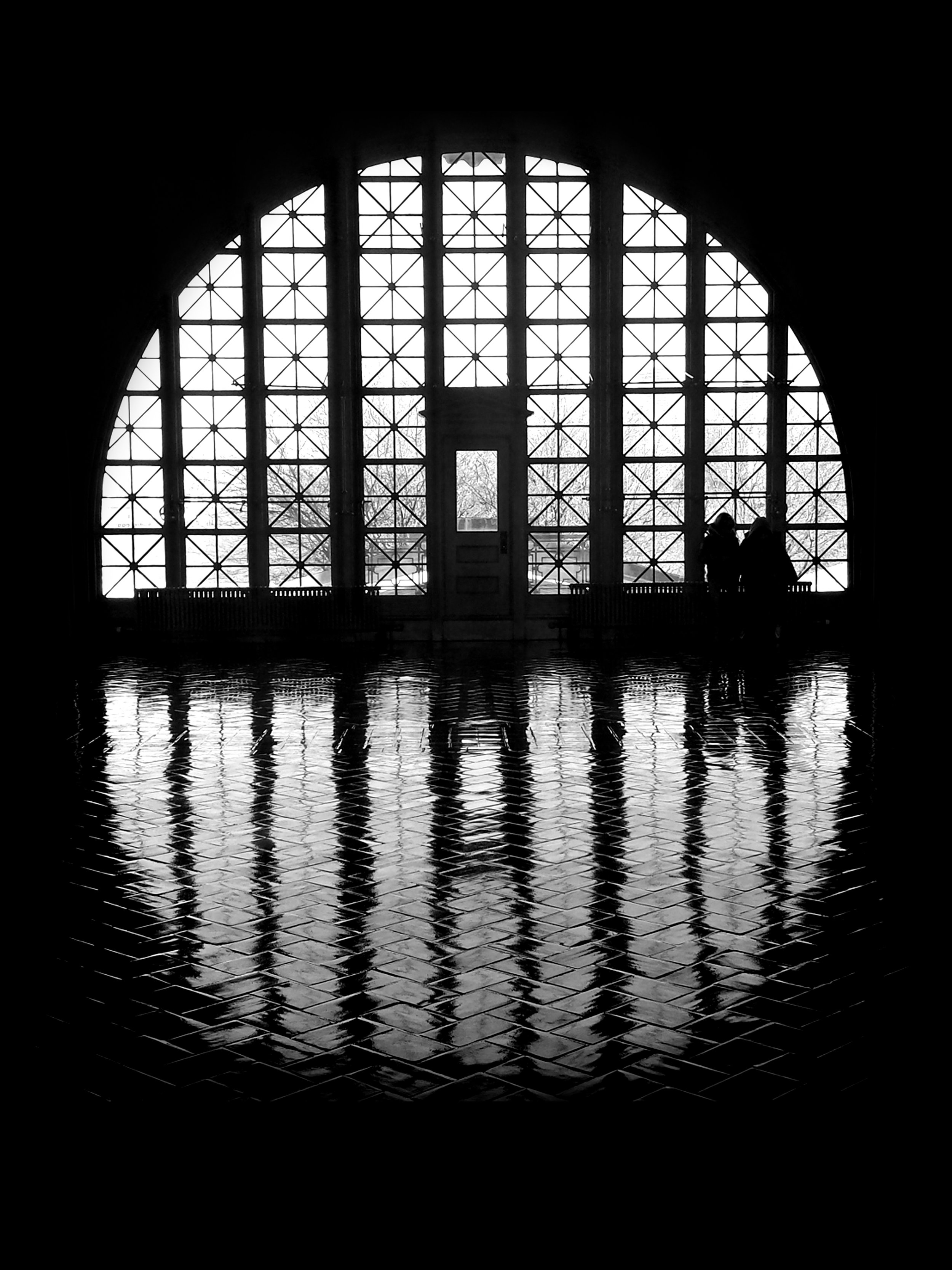 Denise Dell'Olio; Island of Dreams; Sublimated Photo on aluminum; 28" x 37.3"; Captured on Ellis Island, the window and its reflection create a portal—a symbolic gateway for the immigrants who arrived to build our country.; $950