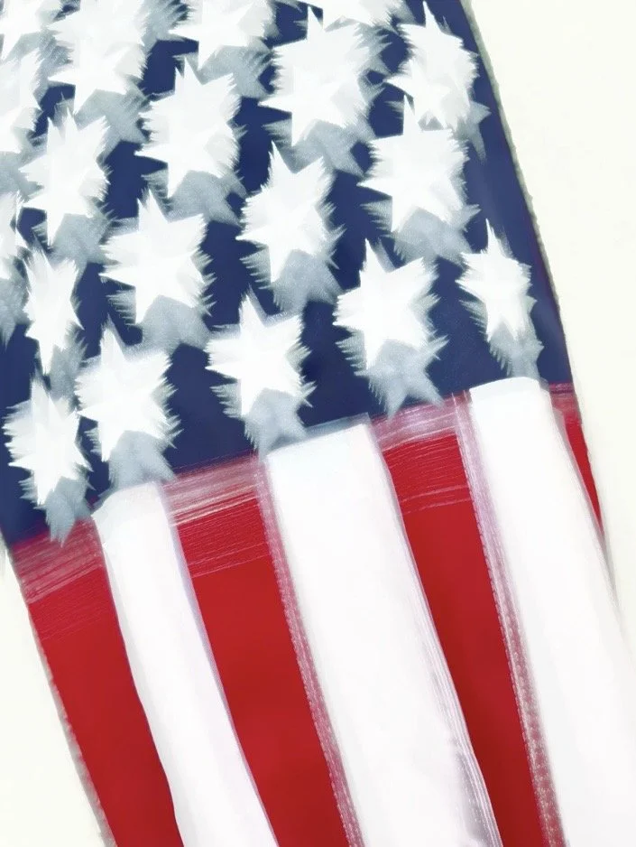 Todd Wax; Old Glory, In Motion; 15.6 x 20.8; Photograph on Tempered Glass; Stars burst like sea spray, stripes ripple like the tide—Old Glory caught mid-motion. Florida-made by Todd Wax, where the Atlantic light meets American spirit.; $595