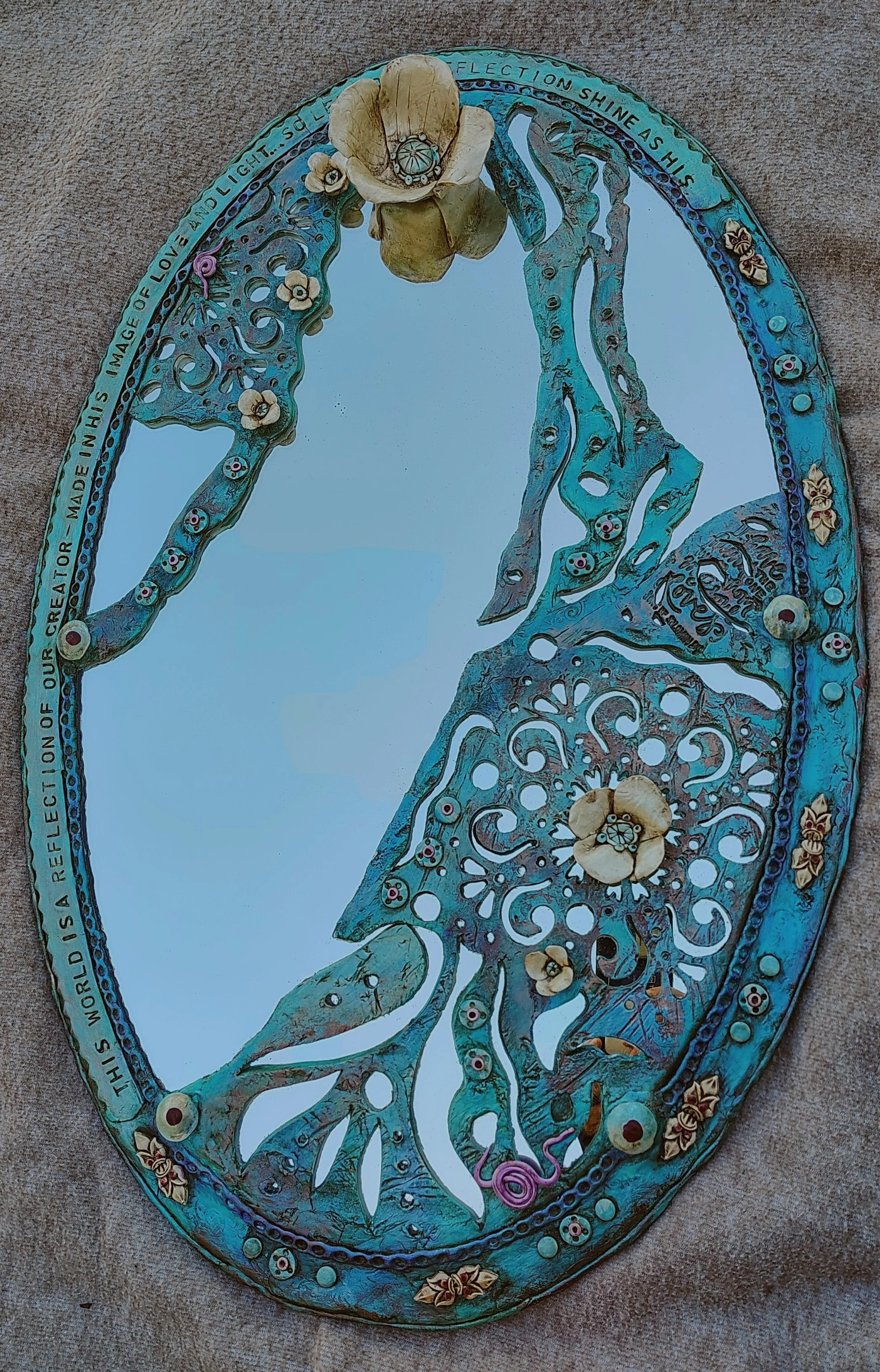 Kim Martinez; Love and Light; Clay on Mirror Glass; 20x30; Both clay and glass require intense heat to reach their final state. This mirrors the "refining fire" of life experiences that shape our character to better reflect our Creator.; $750