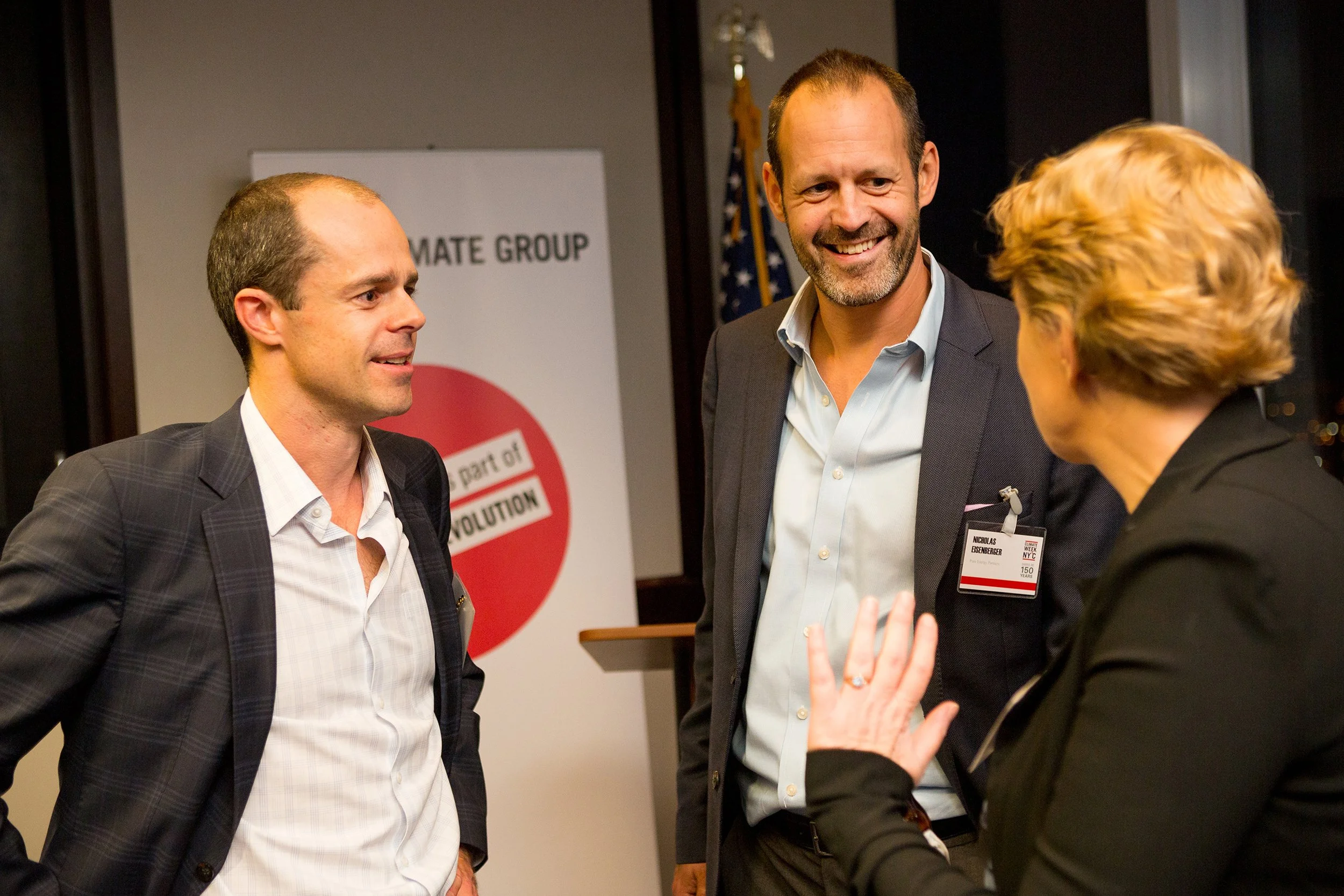 3 people standing in front of branding and networking