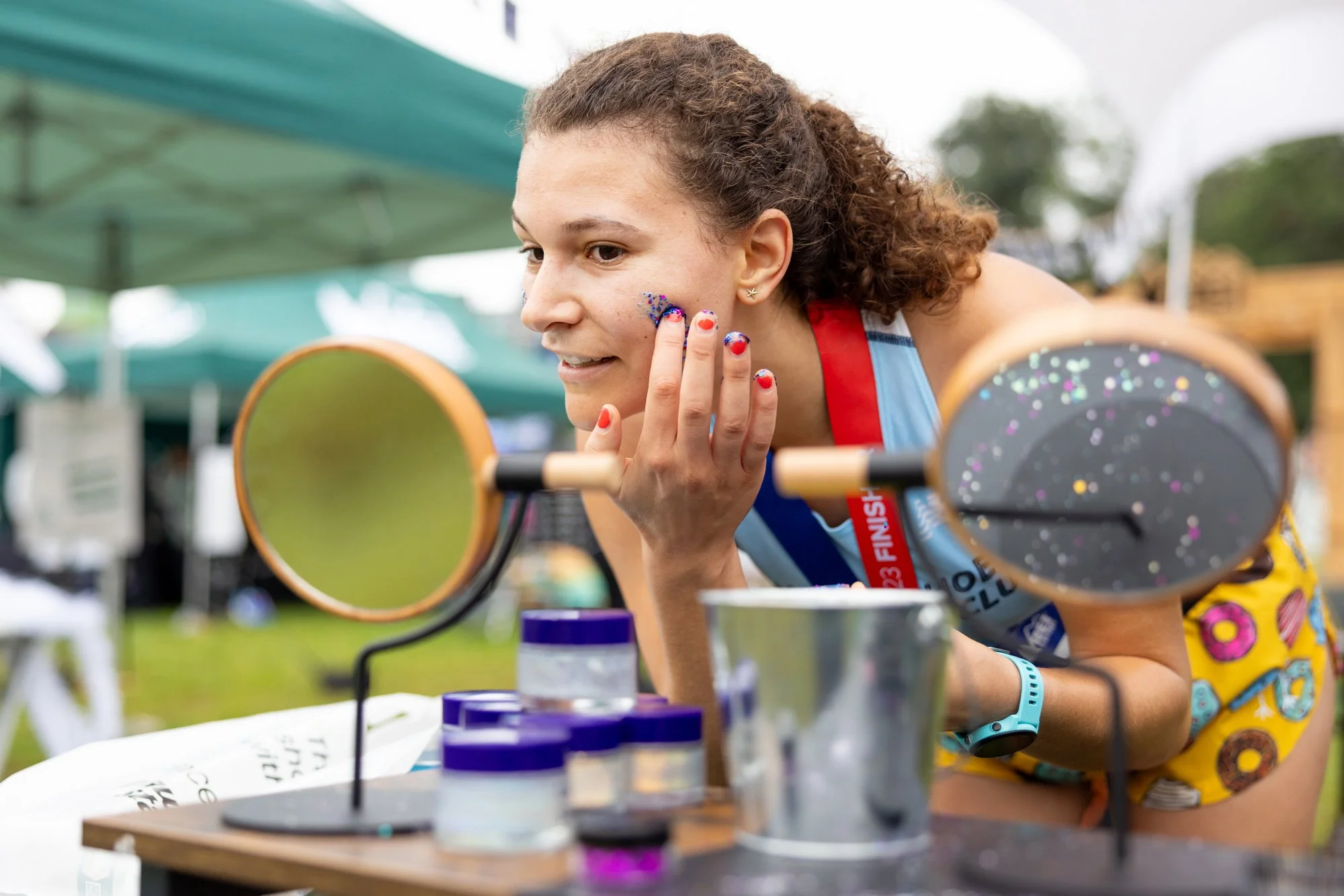Woman putting glitter on cheek